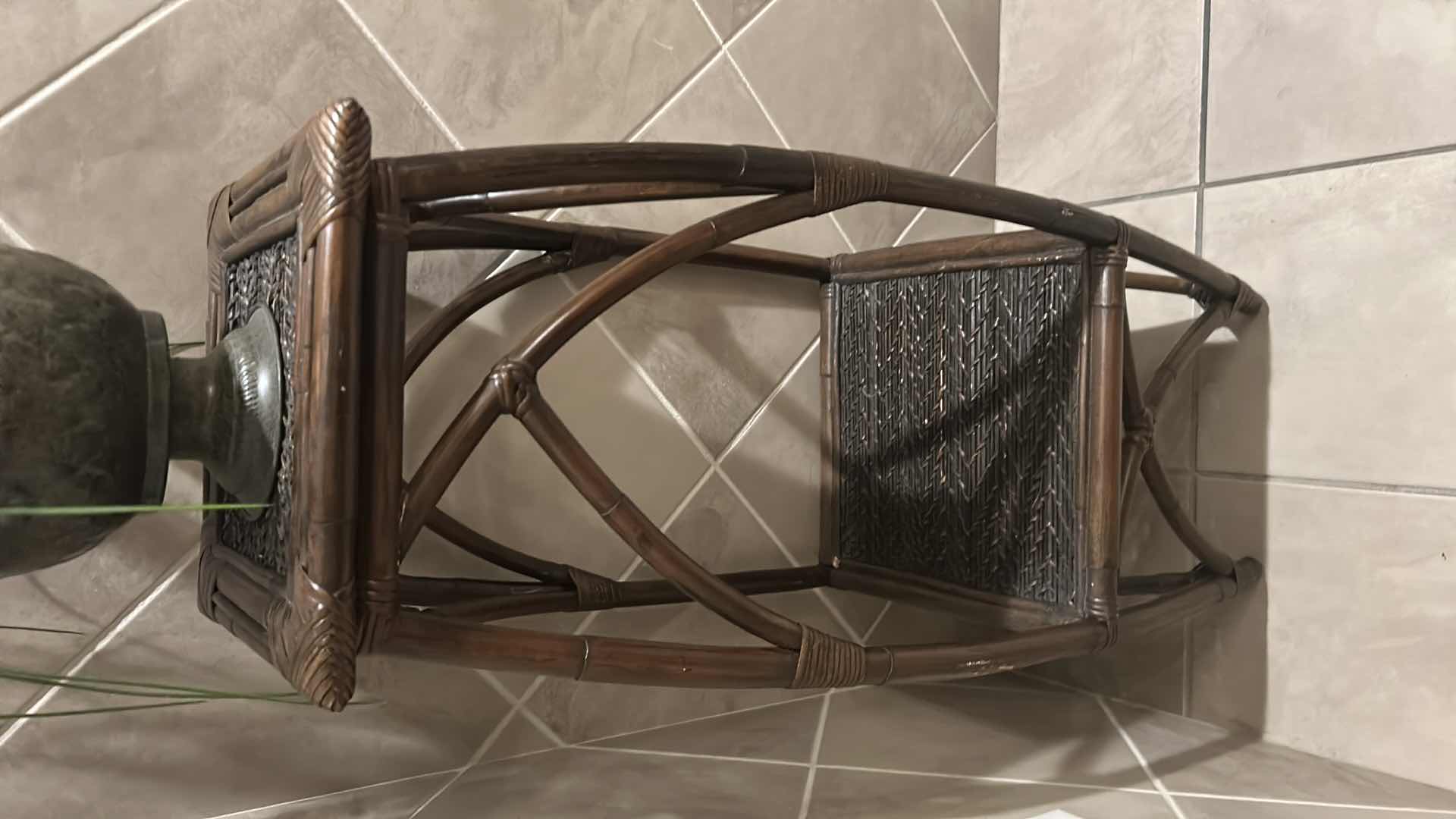 Photo 1 of FAUX ORCHID PLANT IN METAL POT W RATTAN LOWER SHELF AND X SHAPED  BASE H 51"