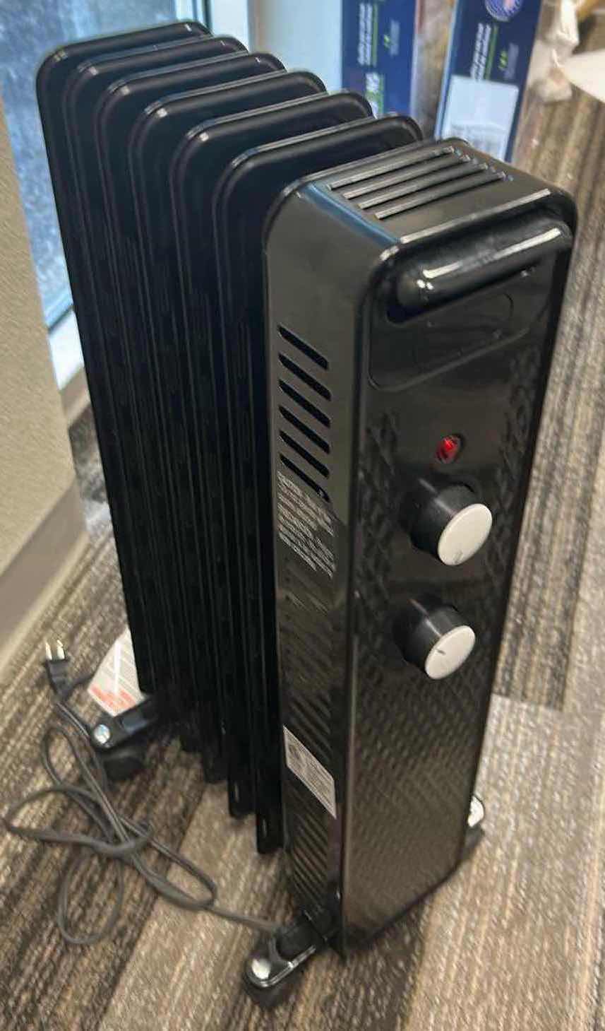 Photo 1 of BLACK PORTABLE HEATER ON ROLLERS