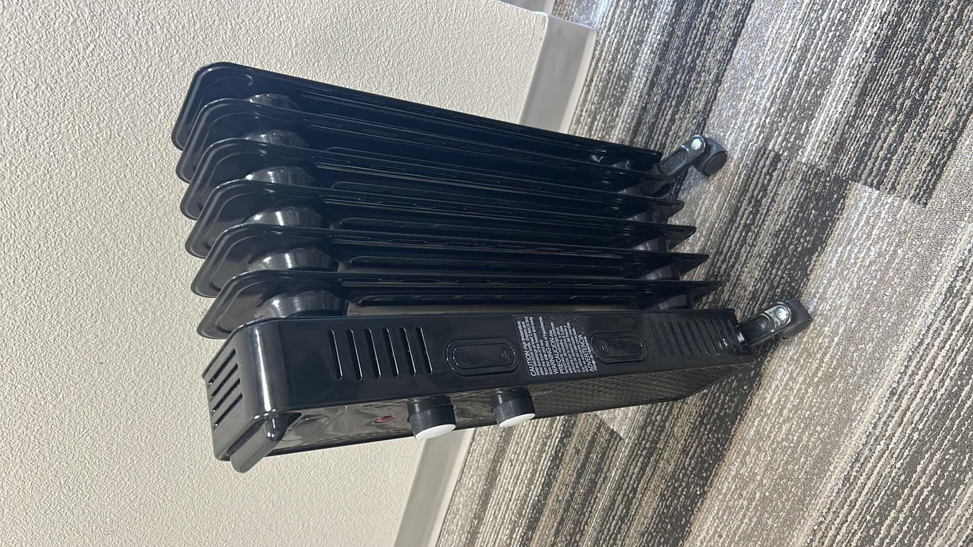 Photo 1 of BLACK PORTABLE HEATER ON ROLLERS