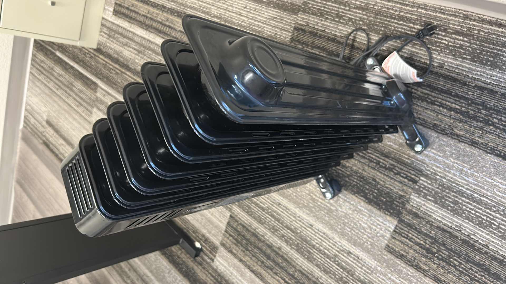 Photo 1 of BLACK PORTABLE HEATER ON ROLLERS