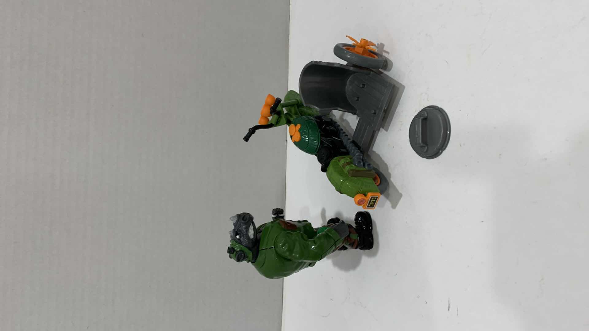 Photo 1 of VINTAGE TEENAGE MUTANT NINJA TURTLES MUTATIN ROCKSTEADY ACTION FIGURE AND A TURTLECYCLE