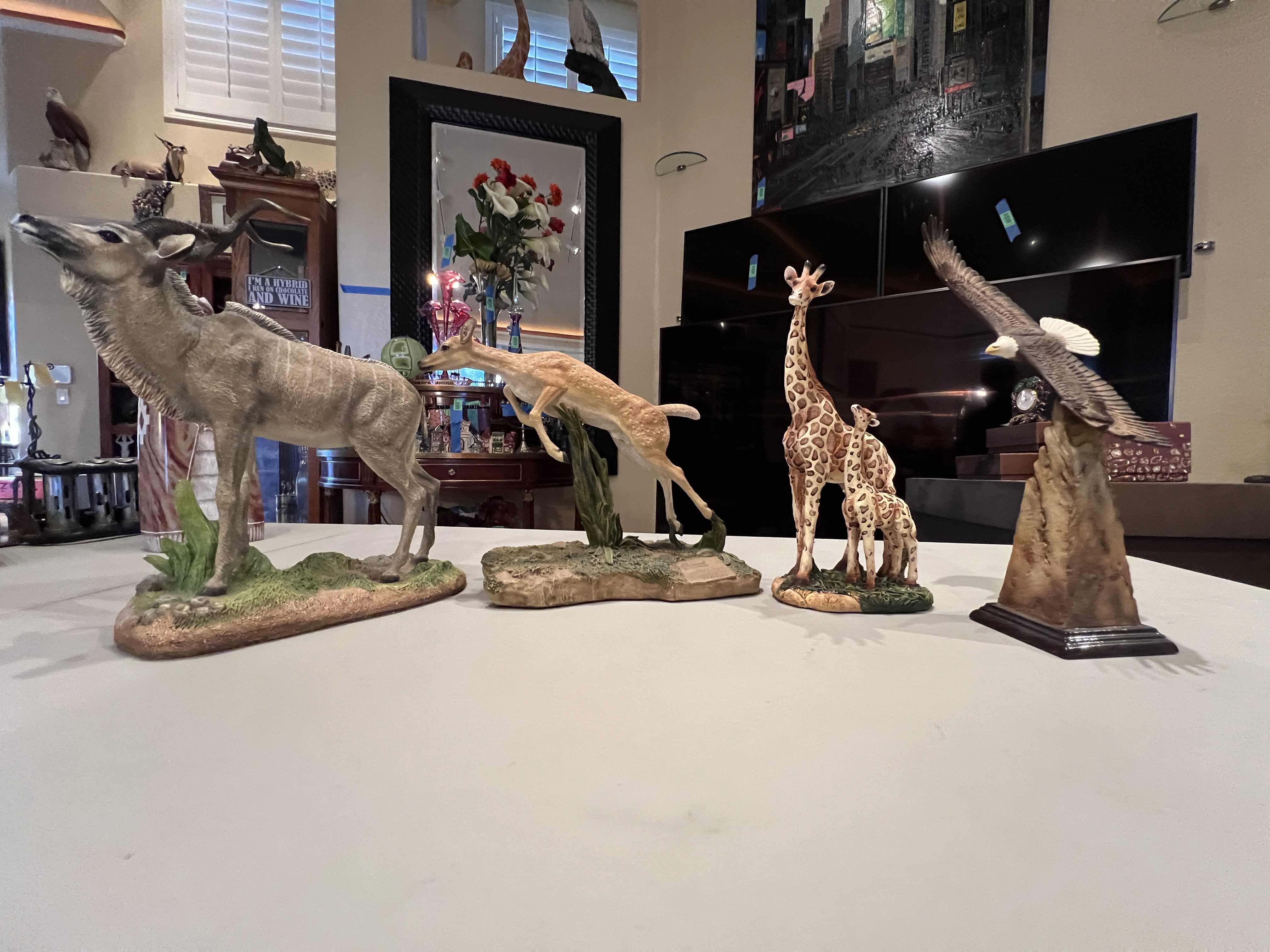 Photo 1 of 4 ASSORTED RESIN FIGURES OF DIFFERENT ANIMALS AND SIZES APPROXIMATELY 10”H
