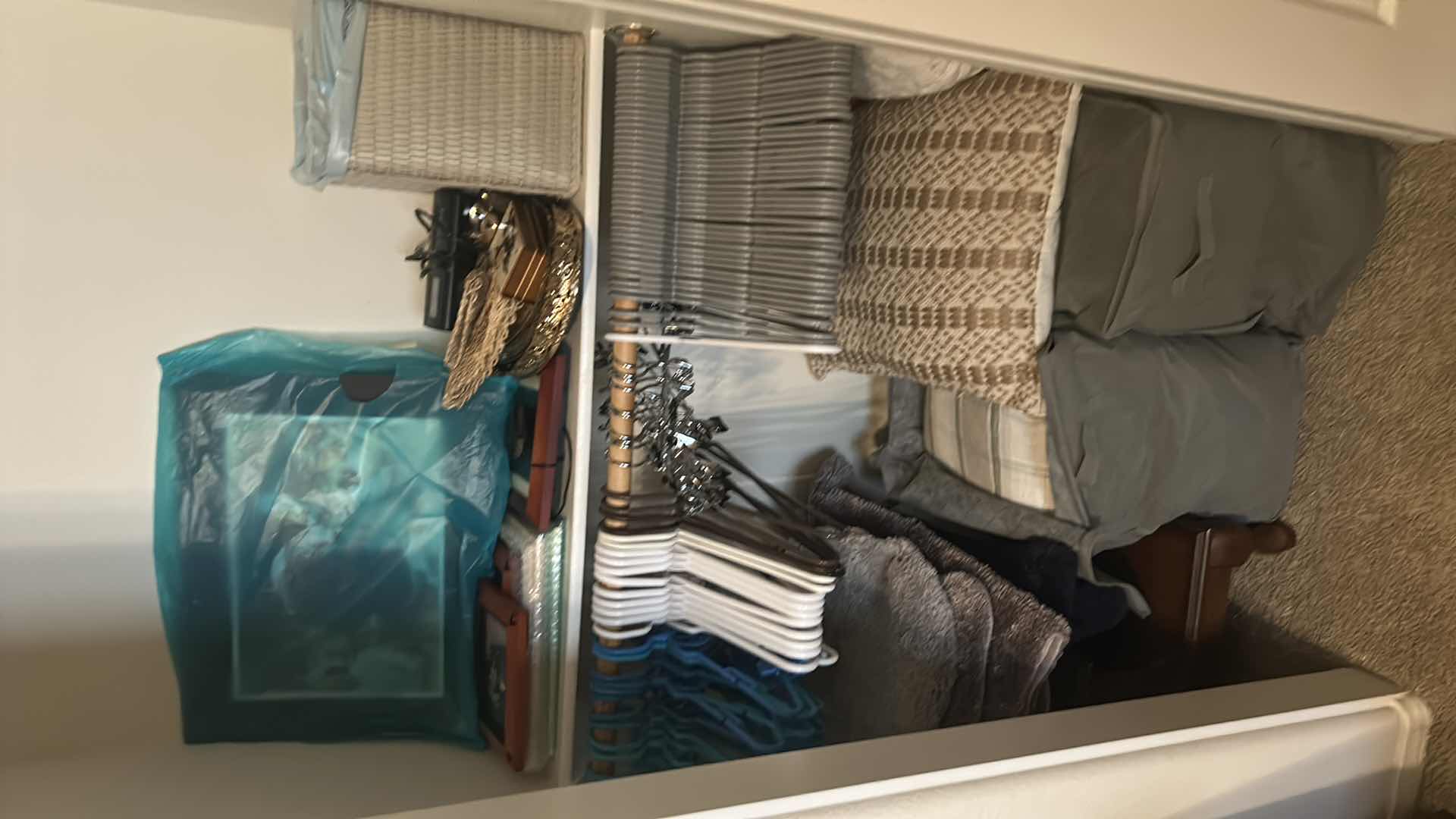 Photo 1 of CONTENTS OF CLOSET HANGERS ASSORTED FRAMES PILLOWS 2 WASTE  BASKETS 