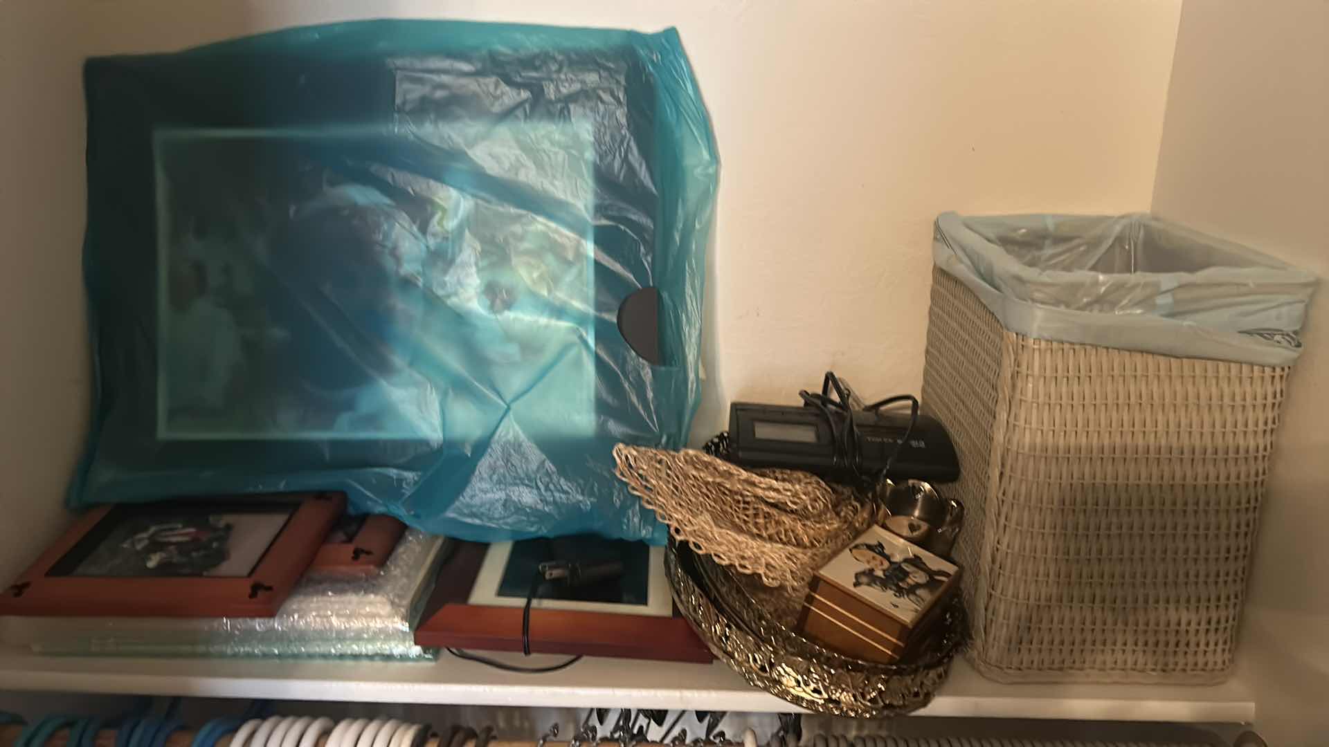 Photo 1 of CONTENTS OF CLOSET HANGERS ASSORTED FRAMES PILLOWS 2 WASTE  BASKETS 