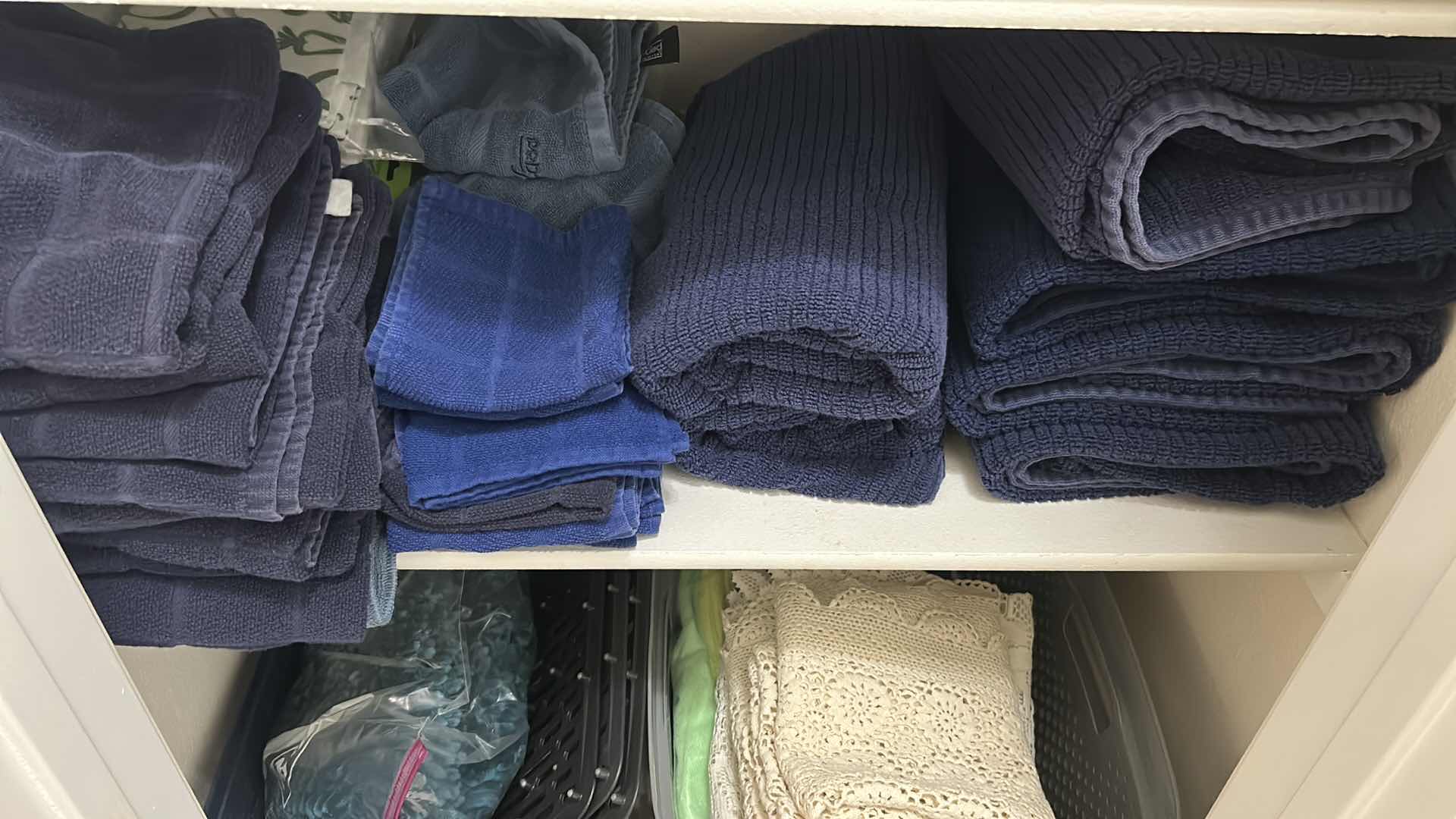 Photo 1 of CONTENTS OF SHELF DARK BLUE BATH TOWELS AND 2 BASKETS W LACE RUNNERS 