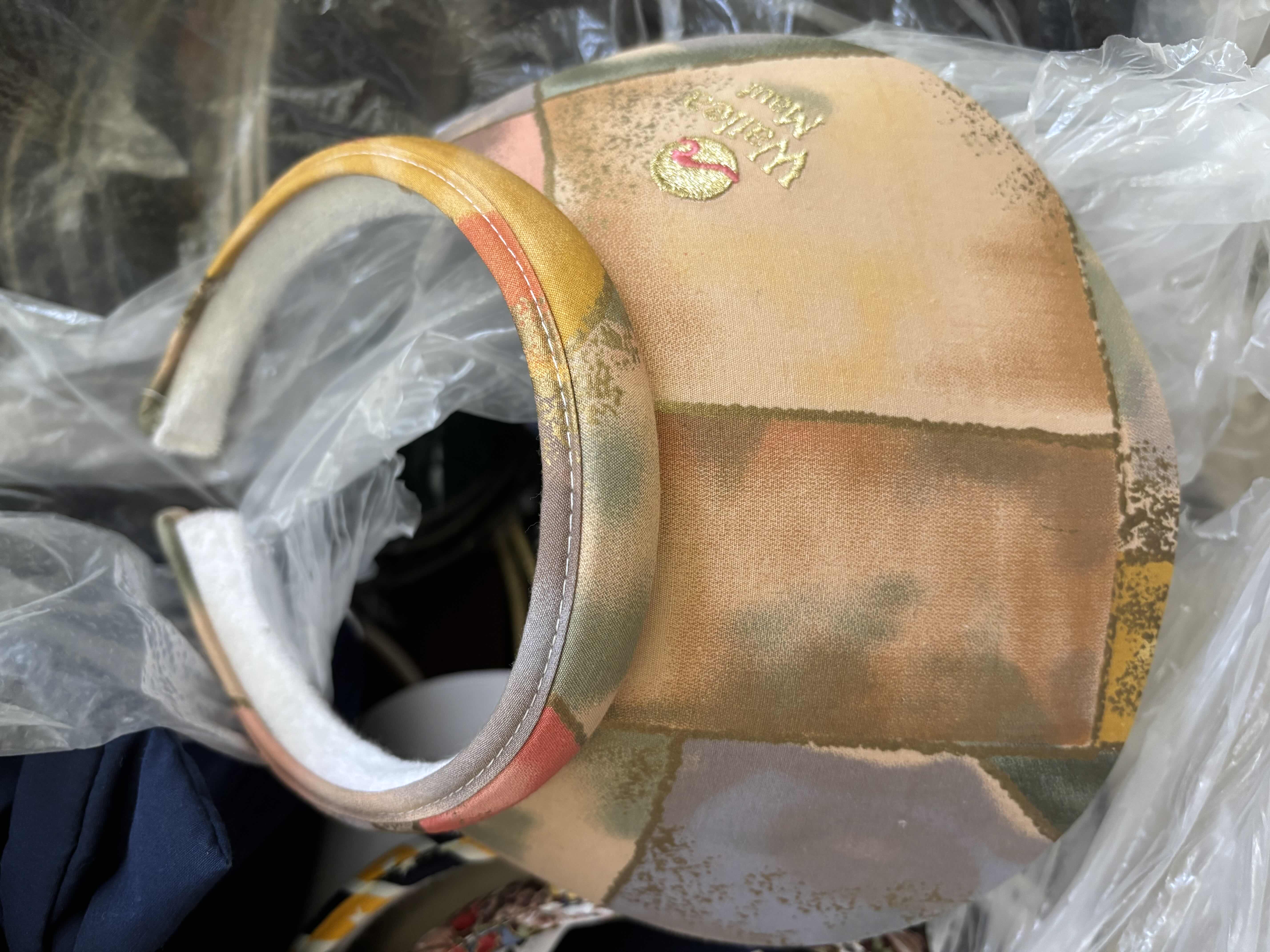 Photo 1 of LARGE BAG OF VISORS IN MULTIPLE COLORS & STYLES