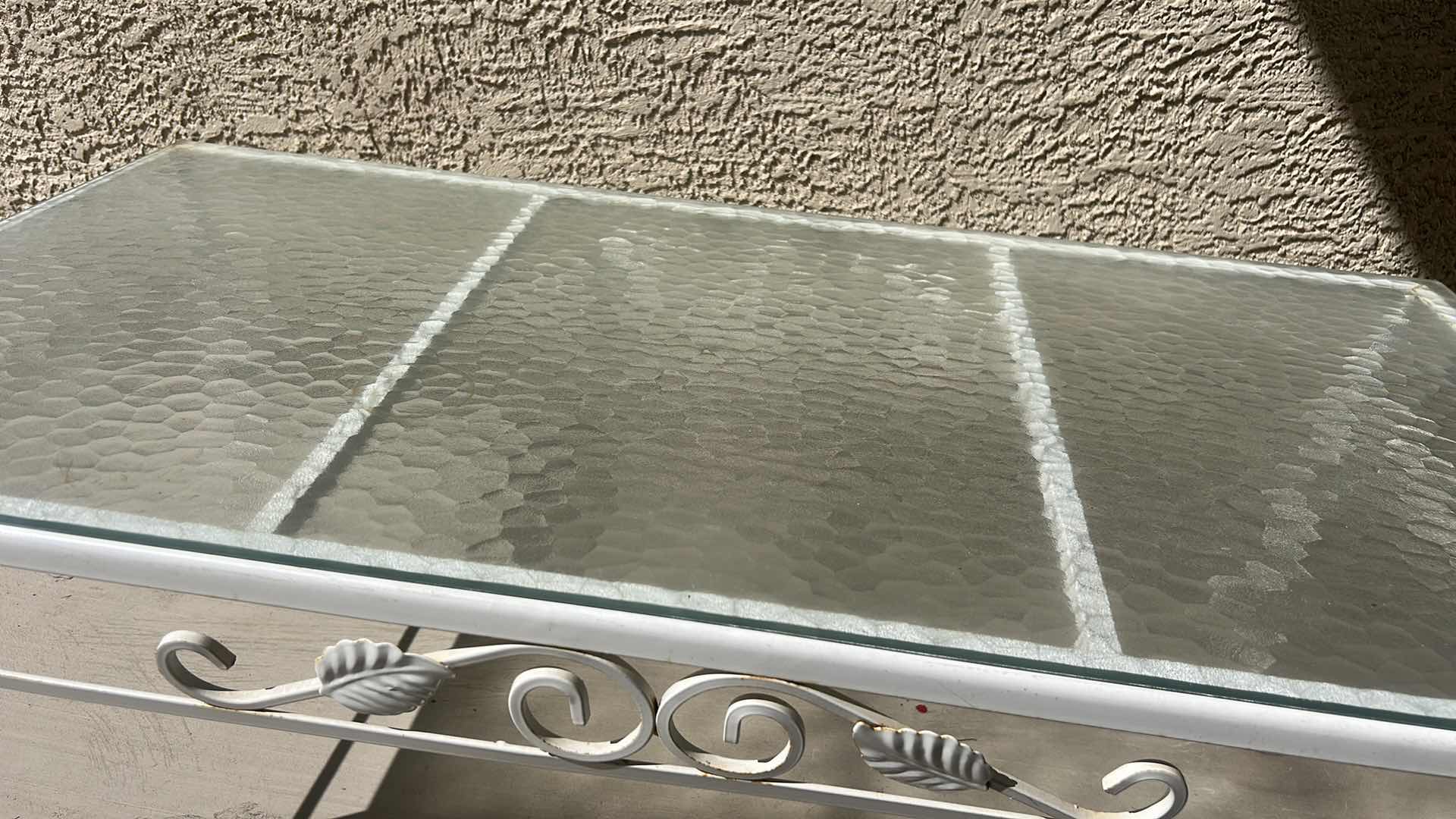 Photo 1 of WHITE WROUGHT IRON PATIO COFFEE TABLE W A GLASS TOP, OFTEN STYLED IN THE HOLLYWOOD REGENCY FASHION. 40“ X 20“ X H14 1/4“