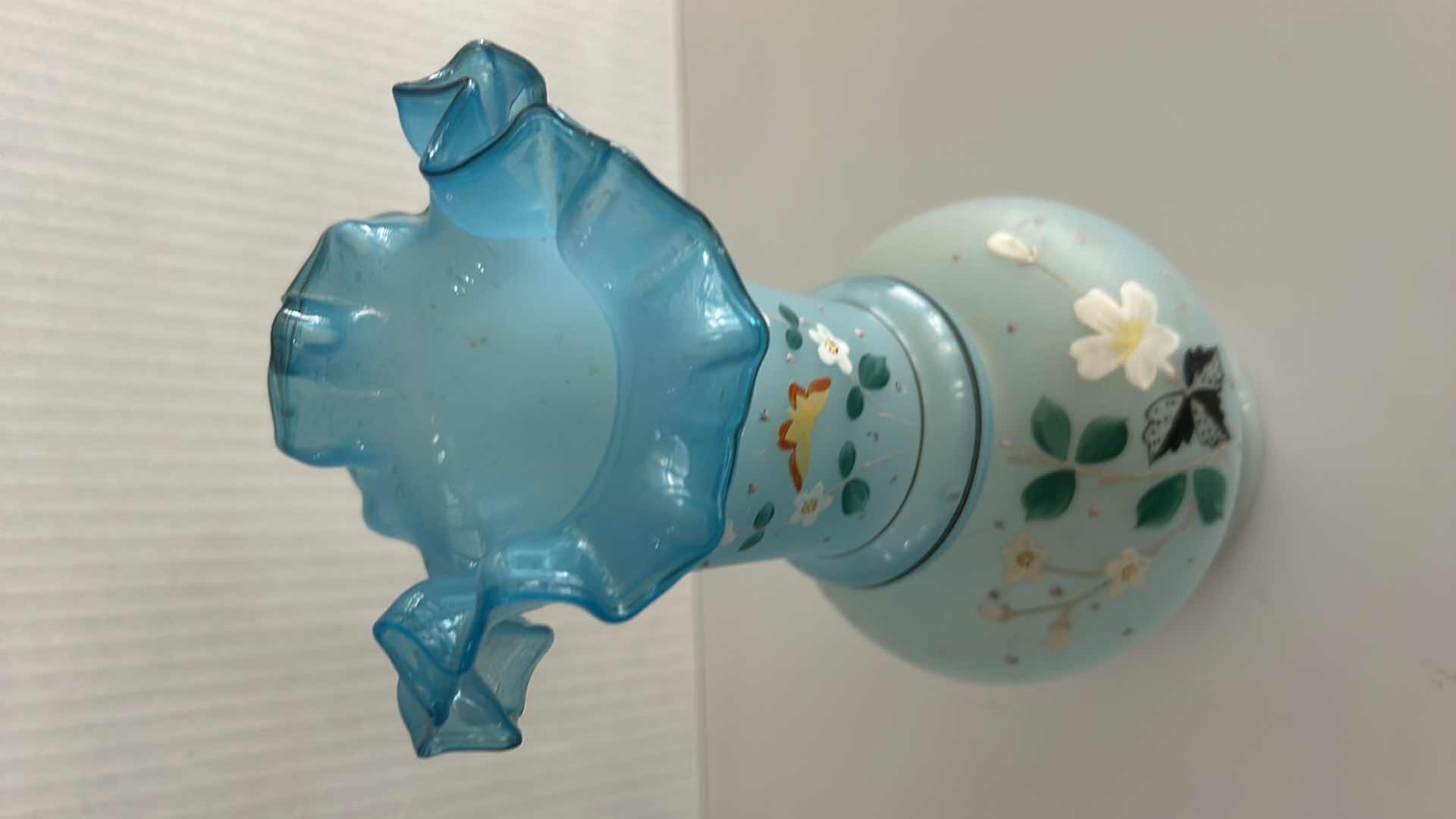 Photo 1 of VINTAGE BRISTOL GLASS VASE FEATURING A HAND-PAINTED BUTTERFLY & FLORAL ENAMEL DESIGN W A BLUE RUFFLED RIM H10.25