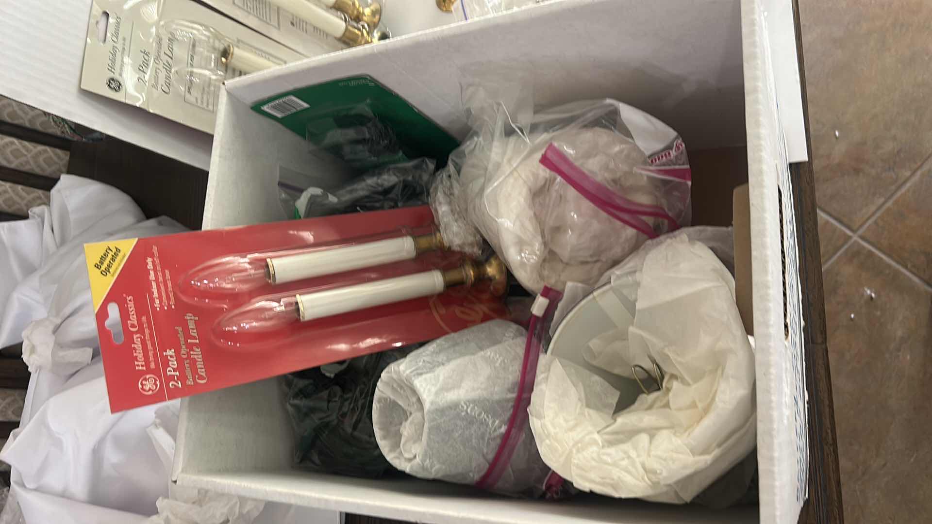 Photo 1 of BOX FULL OF BATTERY CANDLES, SMALL PLEATED SHADES FOR CANDLES, BULBS - BATTERIES