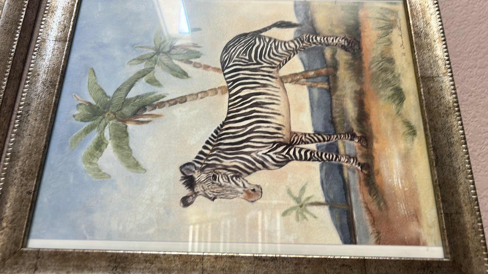 Photo 1 of SET A FOUR  "ANIMALS AFRICANA" PRINT ARTWORK PIECES BY ALEXANDRA CHURCHILL, FEATURING A GIRAFFE, CAMEL, ELEPHANT AND ZEBRA IN RUSTIC GOLD FRAMES. 13” x H 16”