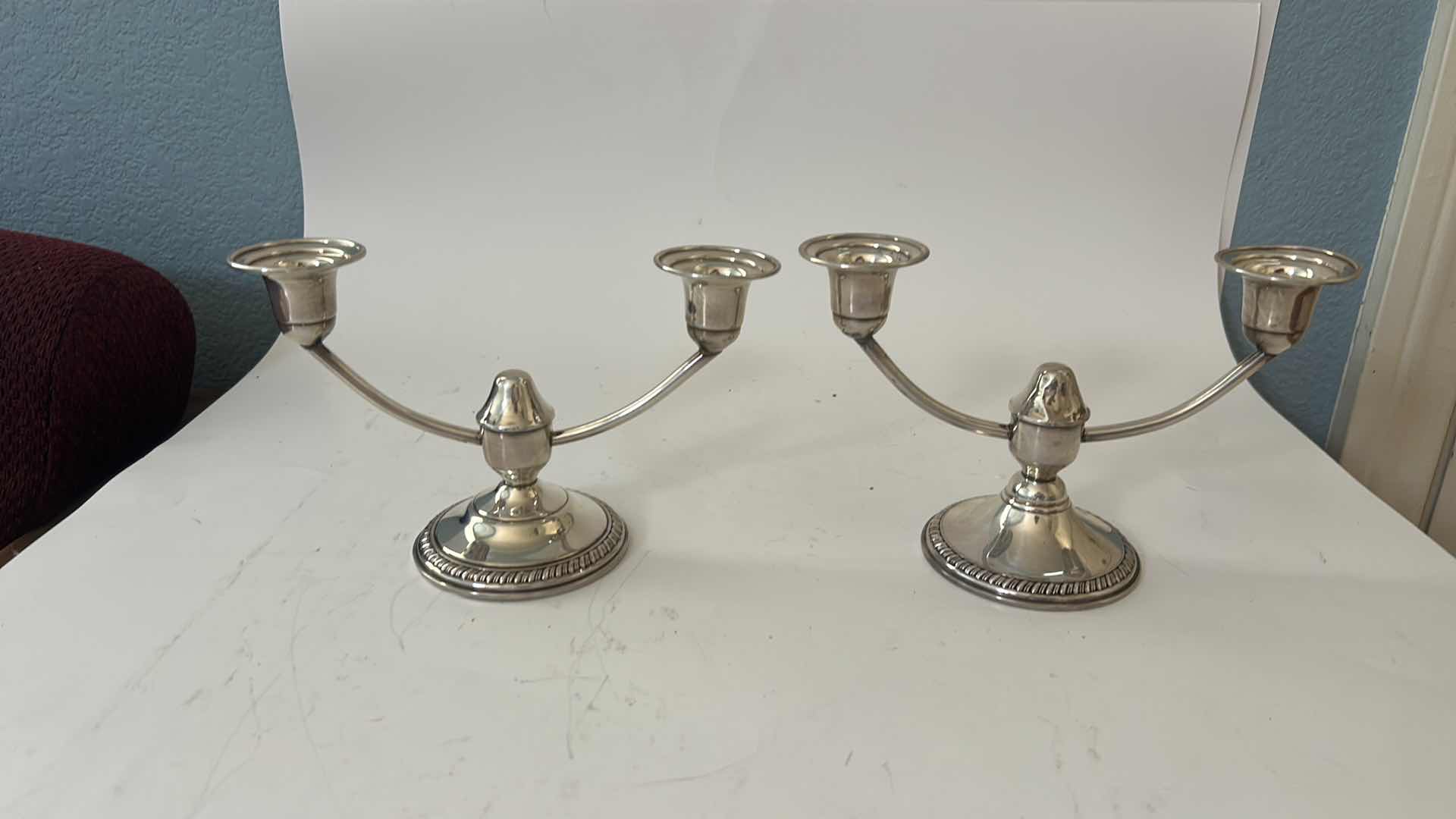 Photo 1 of PAIR OF STAMPED STERLING SILVER CANDELABRAS ( BOTTOMS REINFORCED WITH CEMENT FOR STABILITY)H5”