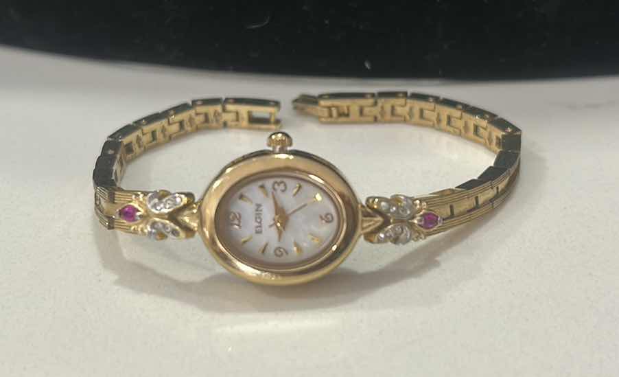 Photo 1 of VINTAGE ELGIN PETITE DRESS WATCH MODEL EG8077 MOTHER-OF-PEARL OVAL DIAL GENUINE RUBY AND CRYSTAL DIAMOND CHIP ACCENT, GOLD TONE LINKED BRACELET BAND