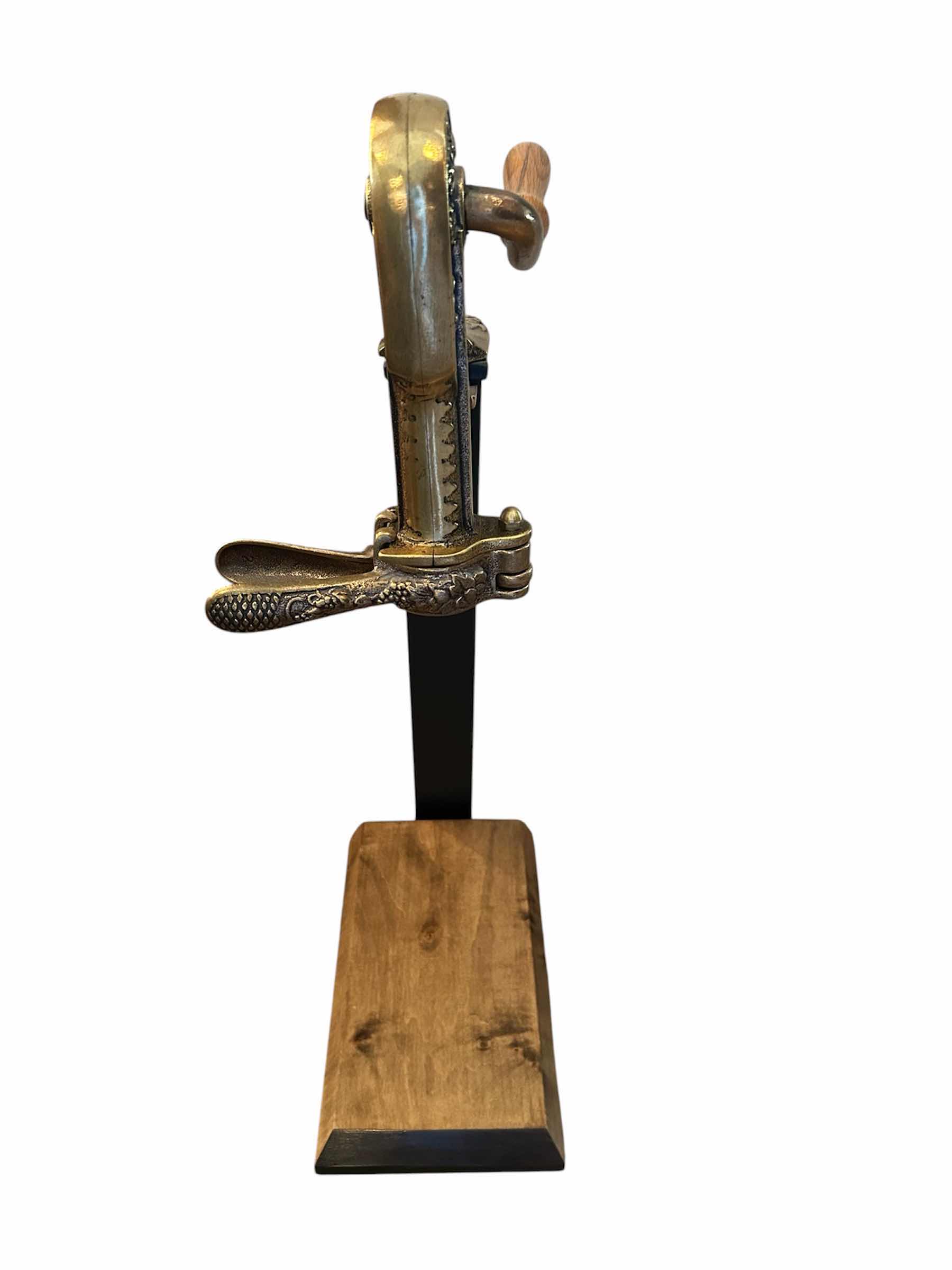 Photo 1 of VINTAGE BACCAUS TABLE TOP WINE BOTTLE OPENER MOUNTED ON ELEVATED WOOD H 23"