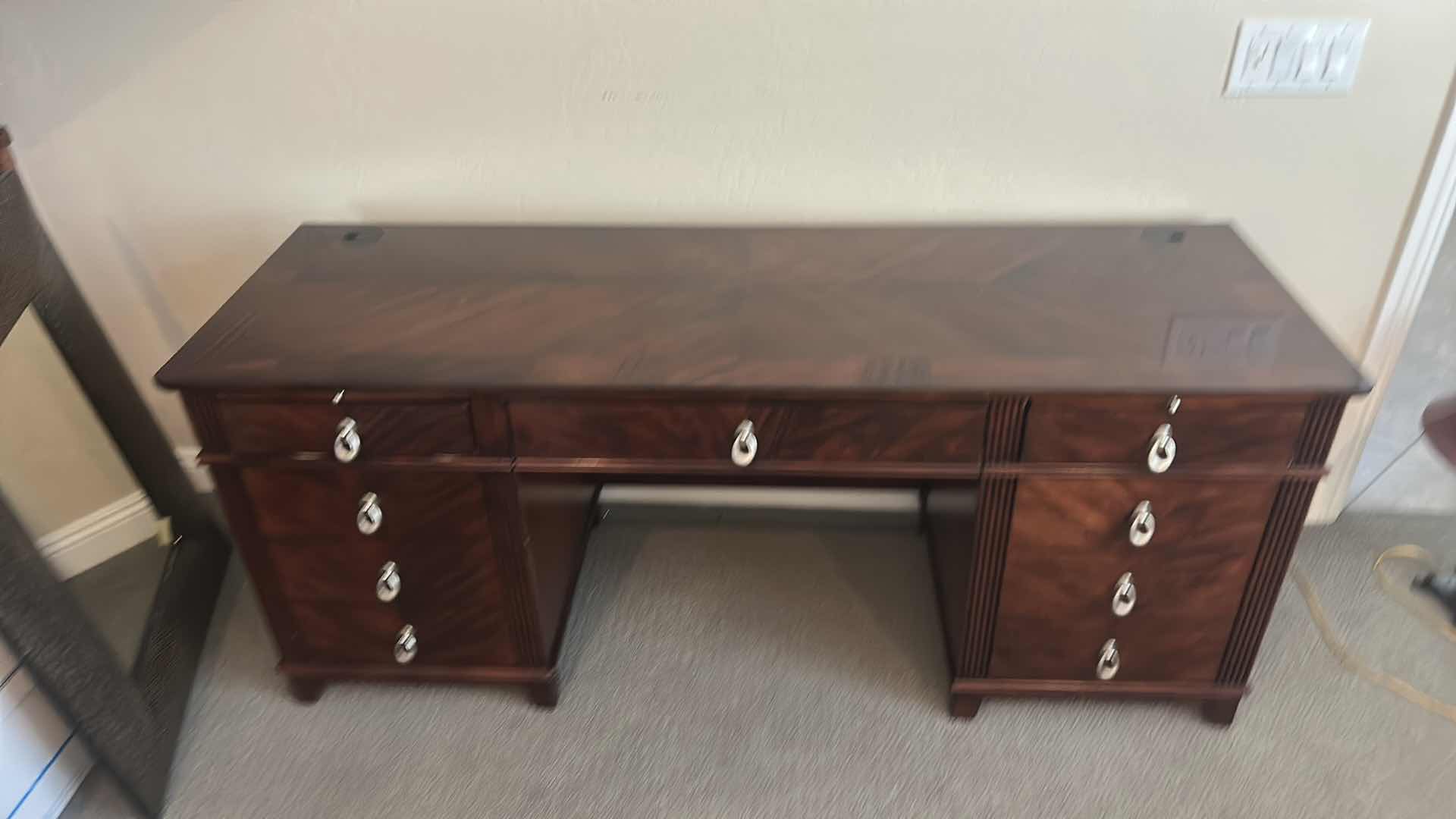 Photo 1 of WALNUT EXECUTIVE DESK WITH MATCHED VENEER, BRASS HARDWARE, KEYBOARD PULLOUT AND BUILT-IN ELECTRICAL PLUGS FOR COMPUTER EQUIPMENT 65” x 2‘ x H30“