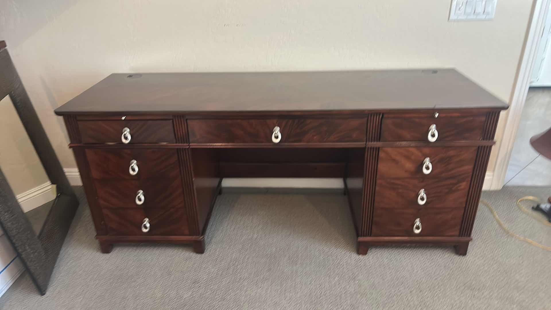 Photo 1 of WALNUT EXECUTIVE DESK WITH MATCHED VENEER, BRASS HARDWARE, KEYBOARD PULLOUT AND BUILT-IN ELECTRICAL PLUGS FOR COMPUTER EQUIPMENT 65” x 2‘ x H30“