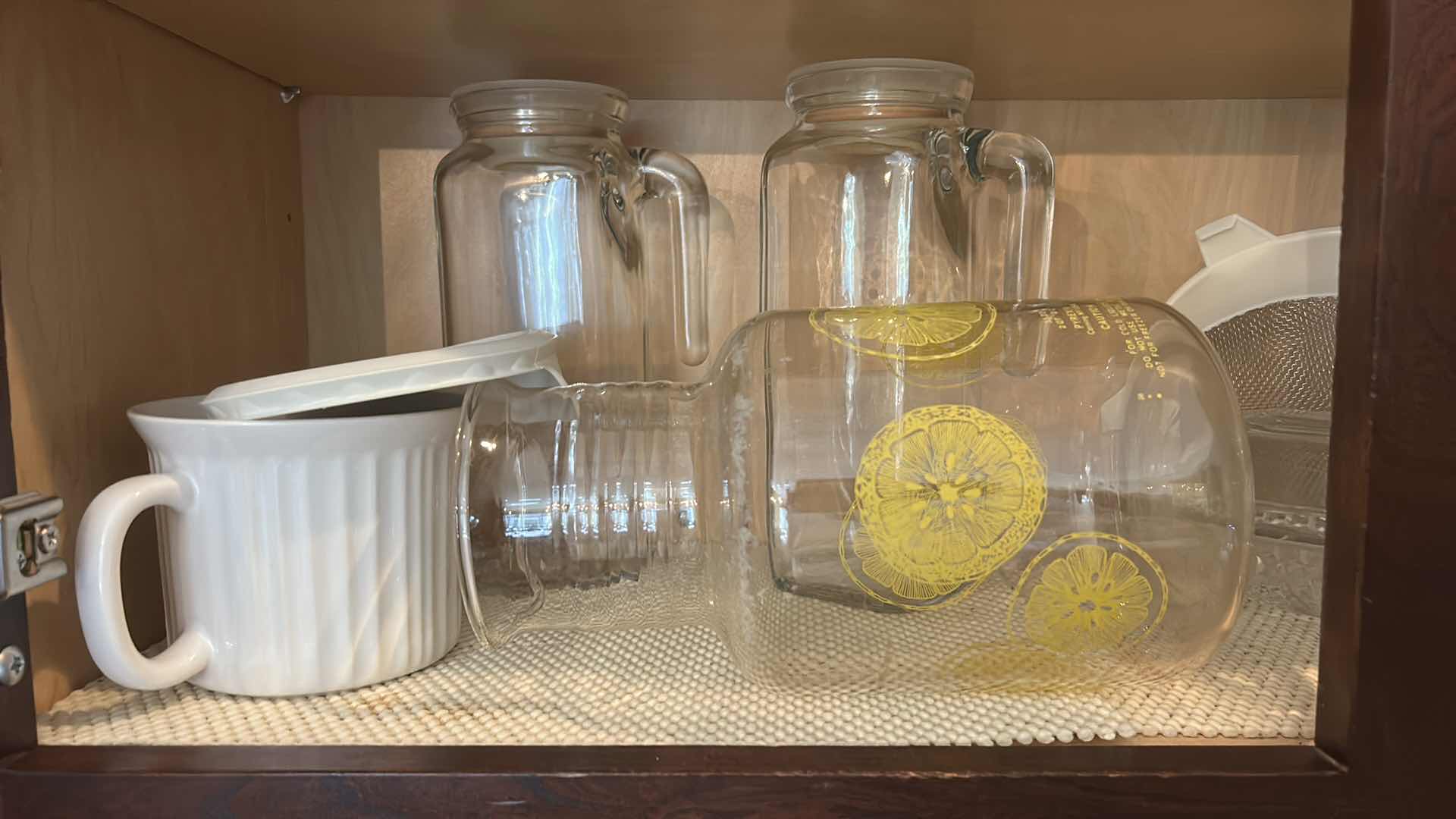 Photo 1 of CONTENTS IN KITCHEN CABINET- PITCHERS, COOKBOOKS, MEASURING CUPS AND MORE