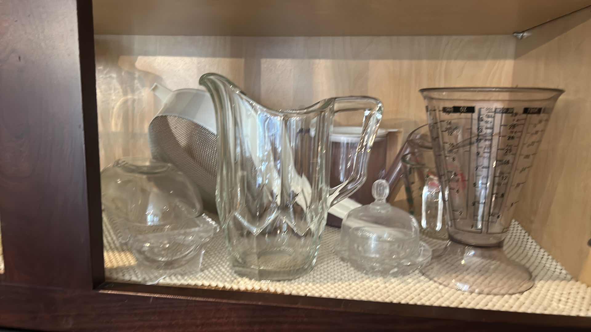 Photo 1 of CONTENTS IN KITCHEN CABINET- PITCHERS, COOKBOOKS, MEASURING CUPS AND MORE