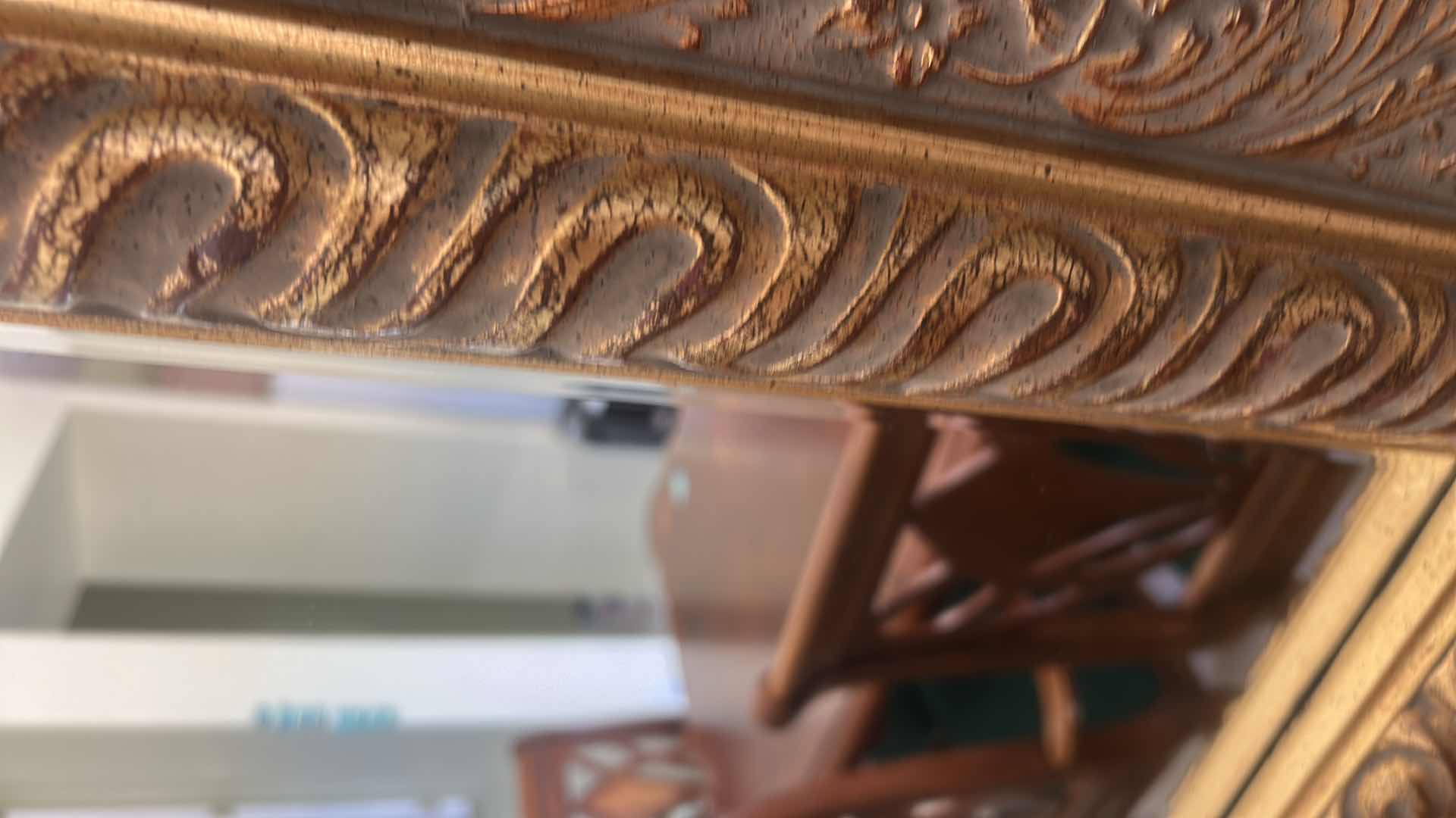 Photo 1 of VINTAGE-STYLE RECTANGULAR BEVELED MIRROR FEATURING A LARGE WOOD GOLD GILT FRAME WITH ORNATE FLORAL AND VINE CARVINGS. 49 1/2“ x 41“.