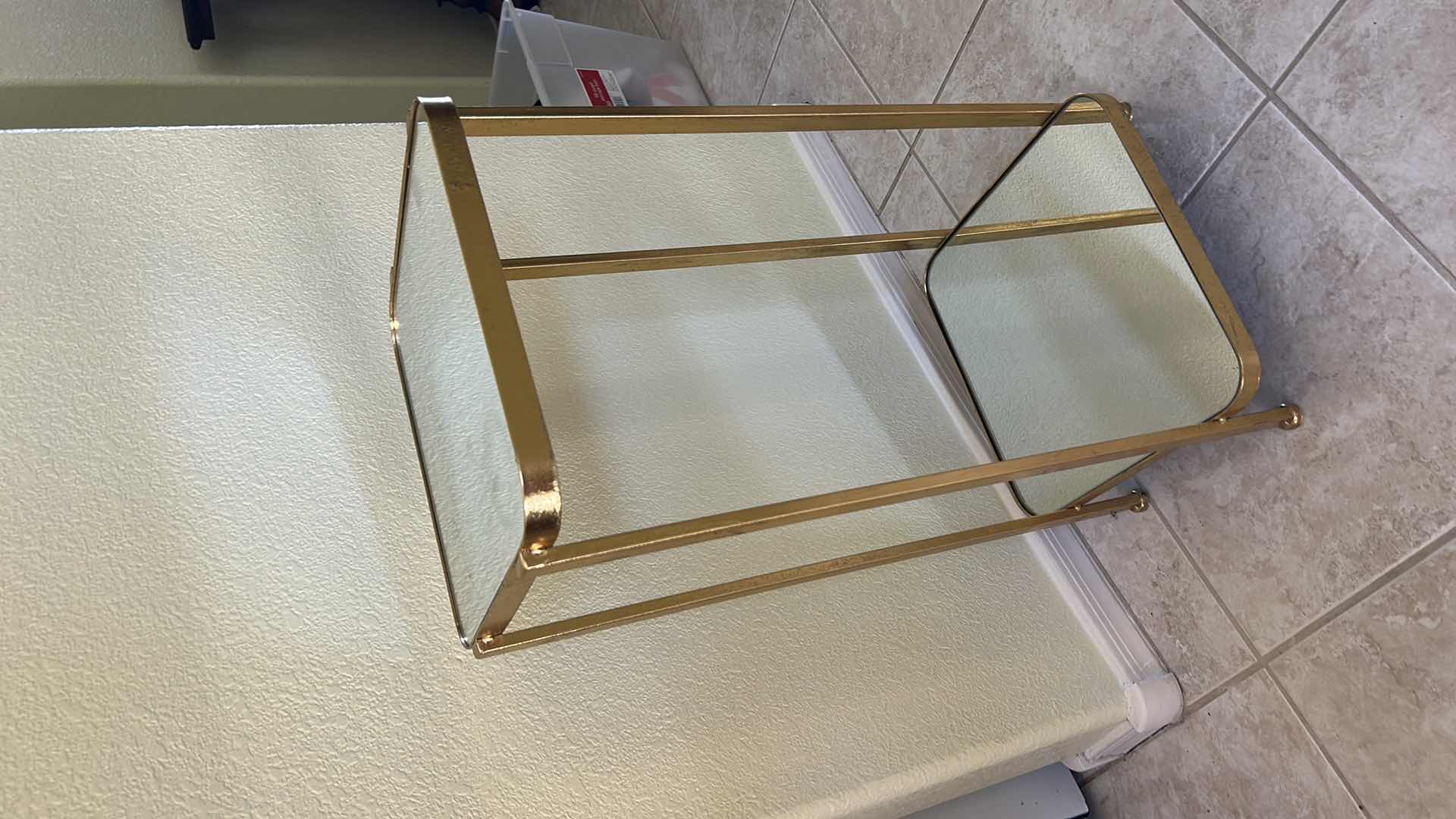 Photo 1 of VINTAGE GOLD METAL SIDE TABLE FEATURING A DECORATIVE FRAME AND GLASS SHELVES. 12“ x 12“ x H25 1/2“