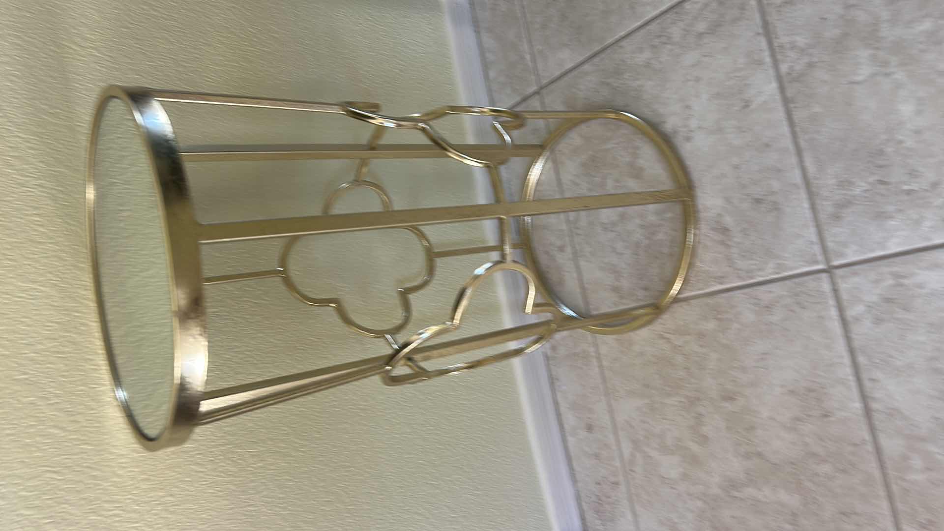 Photo 1 of GOLD METAL SIDE TABLE FROM GRAYSON LANE FEATURING A MIRRORED GLASS TOP AND A CLOVER-SHAPED OPEN FRAME. 12” x H22 1/2”.