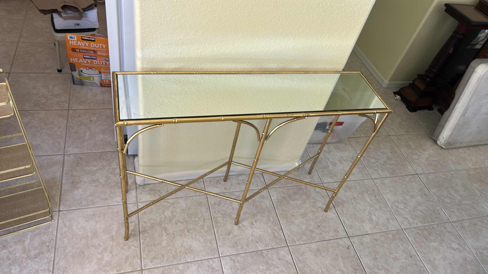 Photo 1 of VINTAGE GOLD BAMBOO-STYLE CONSOLE TABLE FEATURING A GLASS TOP AND AN ELEGANT GOLD-FINISHED METAL FRAME DESIGNED TO RESEMBLE BAMBOO 40“ x 10 1/2“ x H29“.