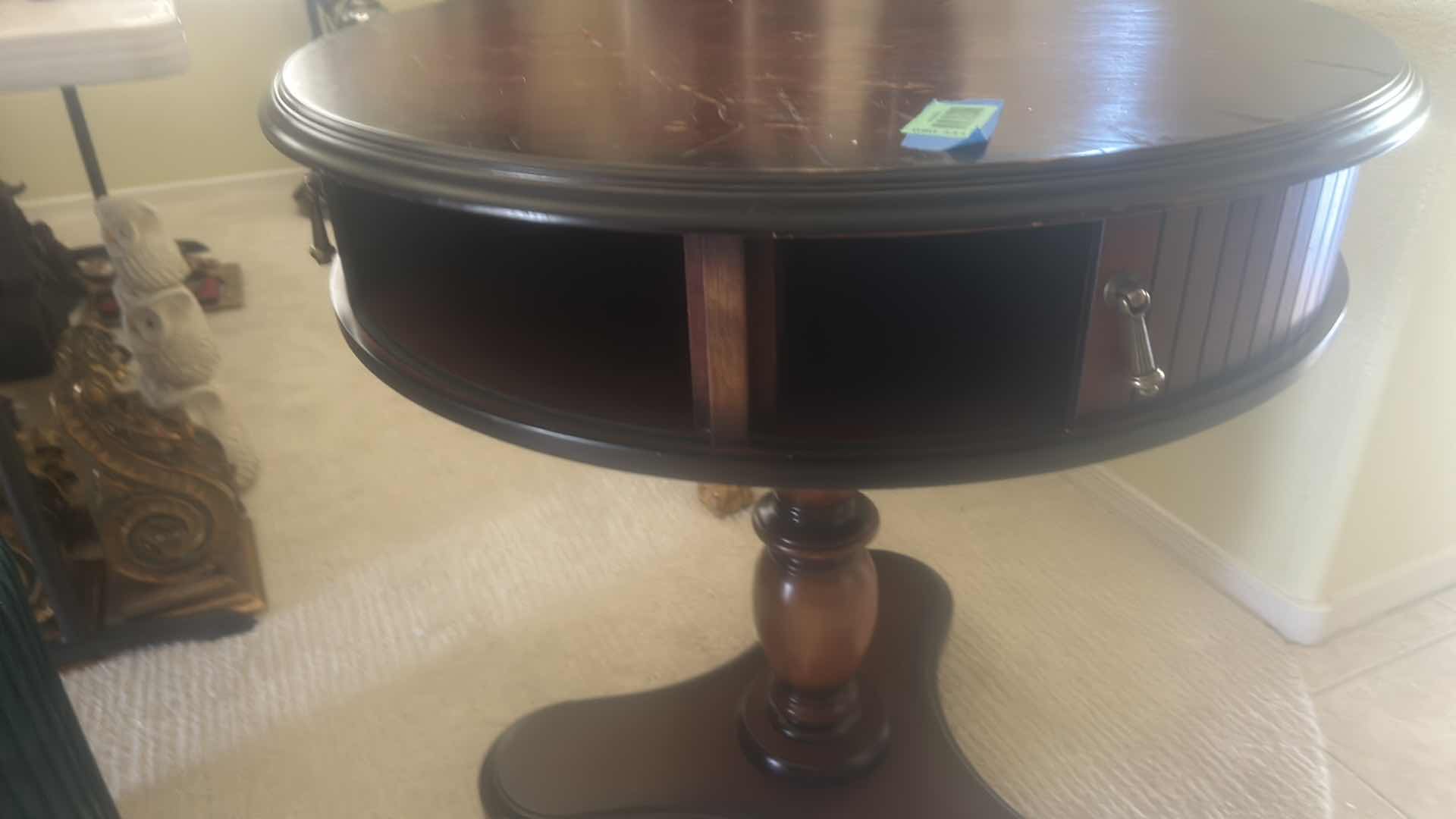 Photo 1 of BUTLER SPECIALTY COMPANY ELLSWORTH FOYER TABLE FEATURING A ROUND TOP, RIBBED CYLINDRICAL CABINET BASE, AND INTERIOR STORAGE COMPARTMENT.  29 1/4“ x 29 1/2“.
