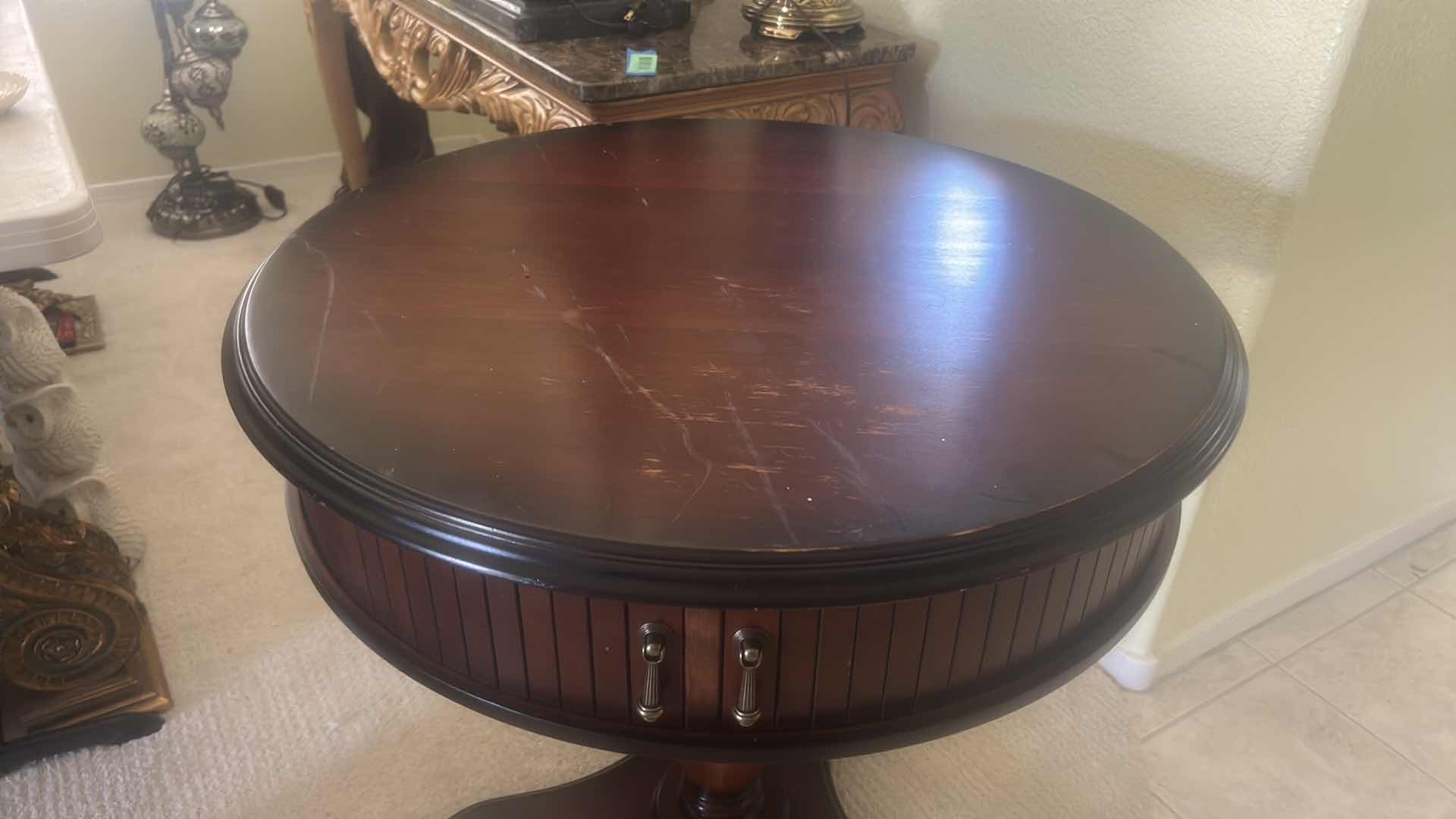 Photo 1 of BUTLER SPECIALTY COMPANY ELLSWORTH FOYER TABLE FEATURING A ROUND TOP, RIBBED CYLINDRICAL CABINET BASE, AND INTERIOR STORAGE COMPARTMENT.  29 1/4“ x 29 1/2“.