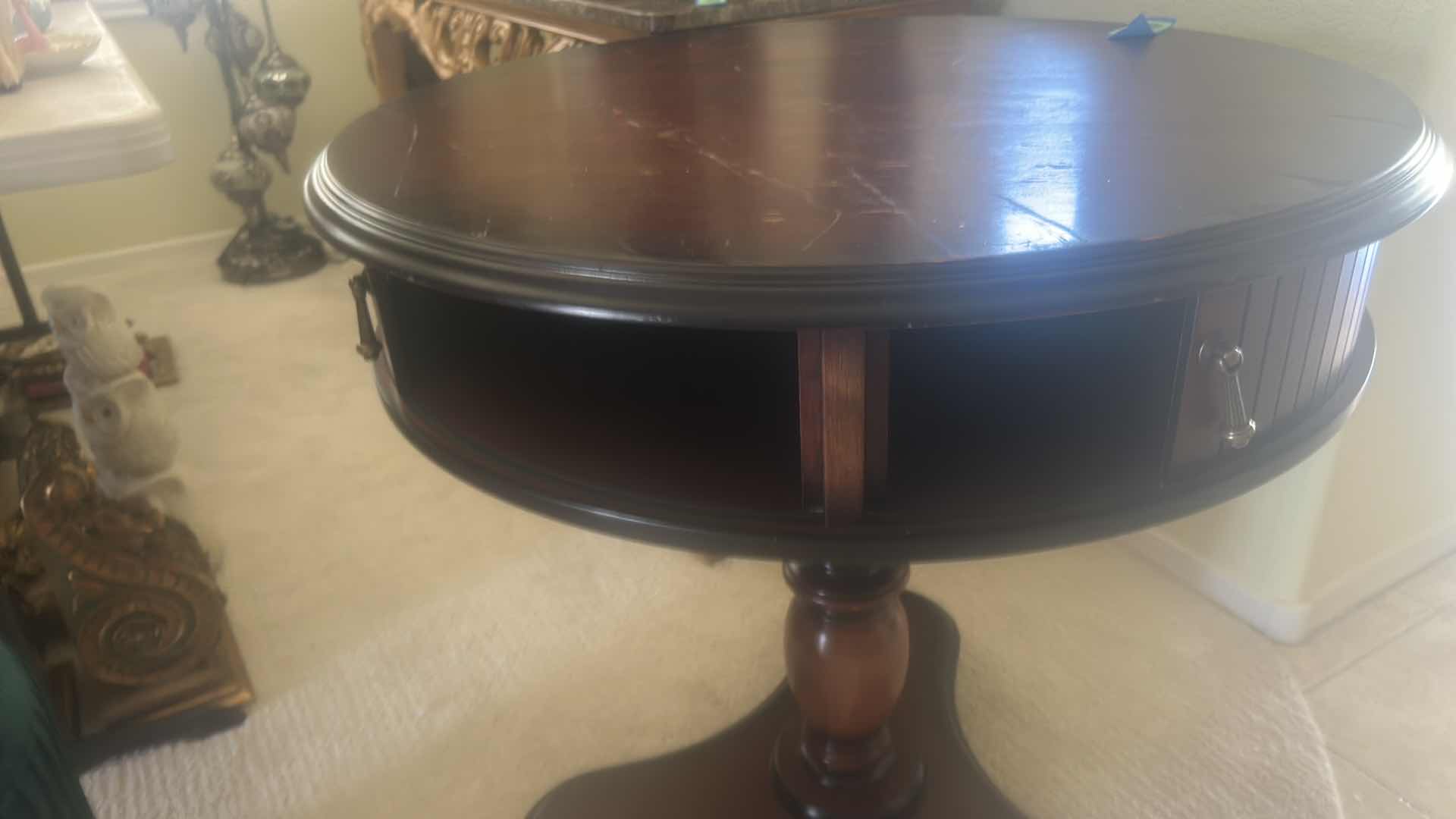 Photo 1 of BUTLER SPECIALTY COMPANY ELLSWORTH FOYER TABLE FEATURING A ROUND TOP, RIBBED CYLINDRICAL CABINET BASE, AND INTERIOR STORAGE COMPARTMENT.  29 1/4“ x 29 1/2“.