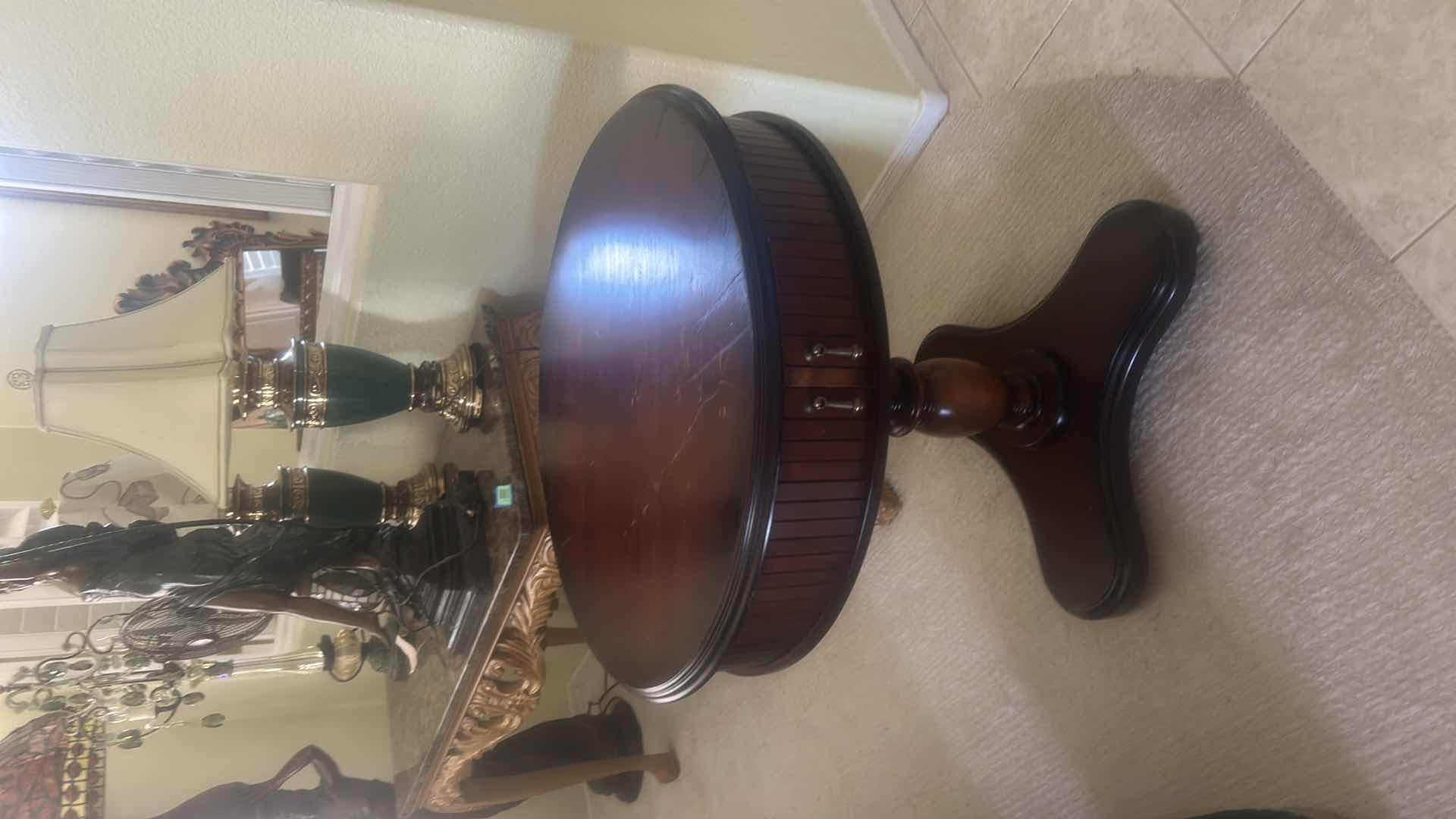 Photo 1 of BUTLER SPECIALTY COMPANY ELLSWORTH FOYER TABLE FEATURING A ROUND TOP, RIBBED CYLINDRICAL CABINET BASE, AND INTERIOR STORAGE COMPARTMENT.  29 1/4“ x 29 1/2“.