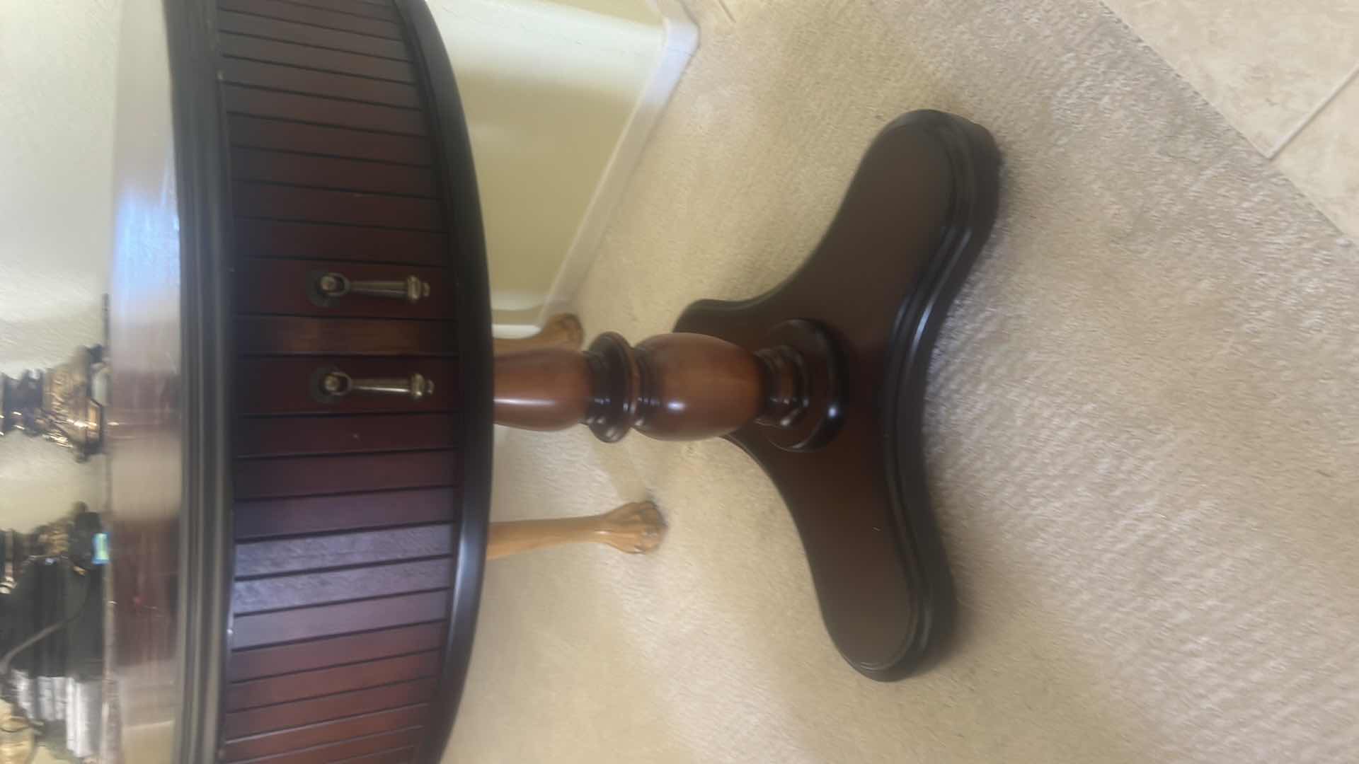 Photo 1 of BUTLER SPECIALTY COMPANY ELLSWORTH FOYER TABLE FEATURING A ROUND TOP, RIBBED CYLINDRICAL CABINET BASE, AND INTERIOR STORAGE COMPARTMENT.  29 1/4“ x 29 1/2“.