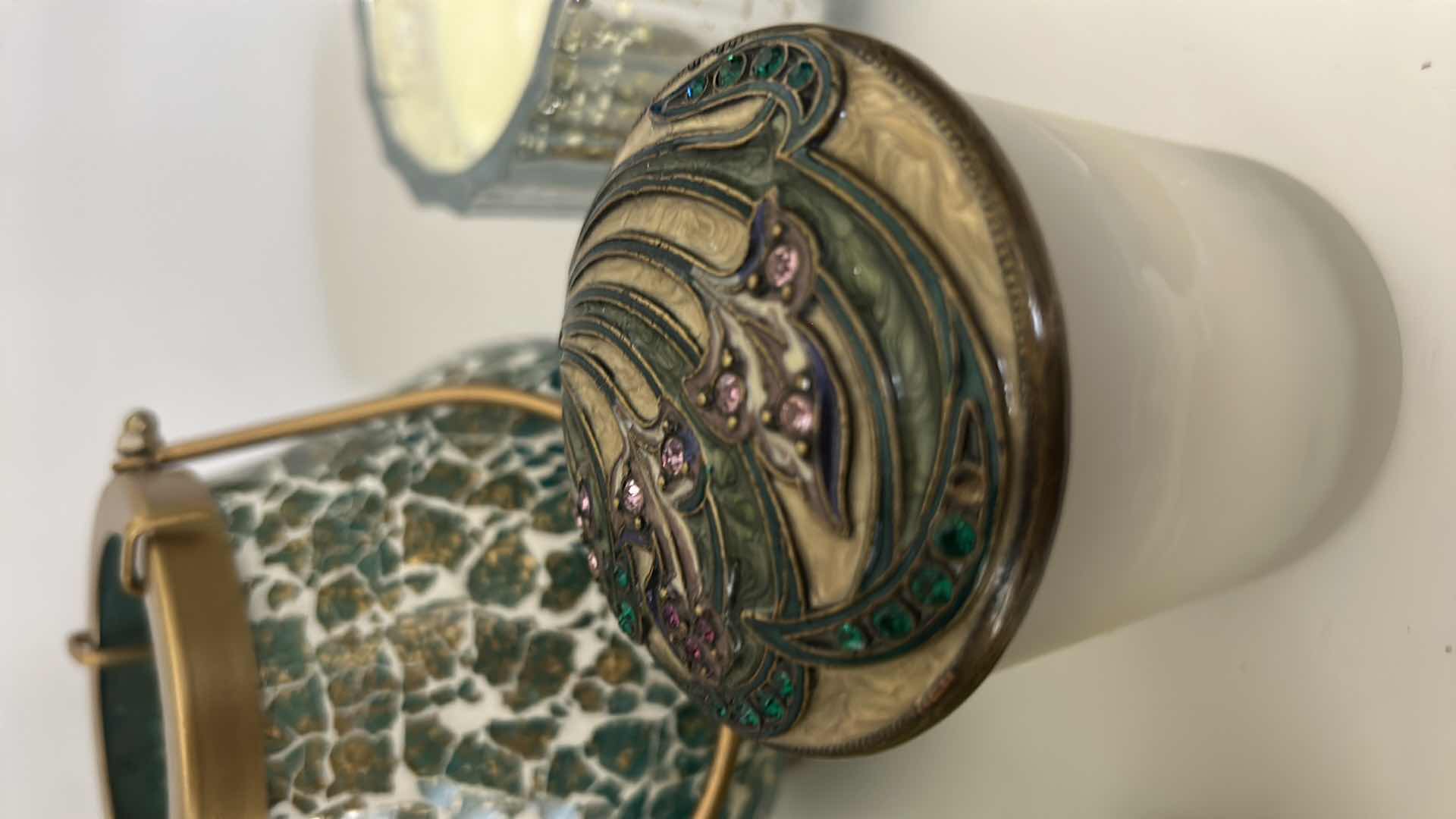 Photo 1 of MOSAIC CANDLE HOLDER LANTERN FEATURES A UNIQUE MIRROR GLASS DESIGN WITH A GOLD HANDLE, DECORATIVE CANDLES AND CANDLE HOLDER WITH  FLOWERS