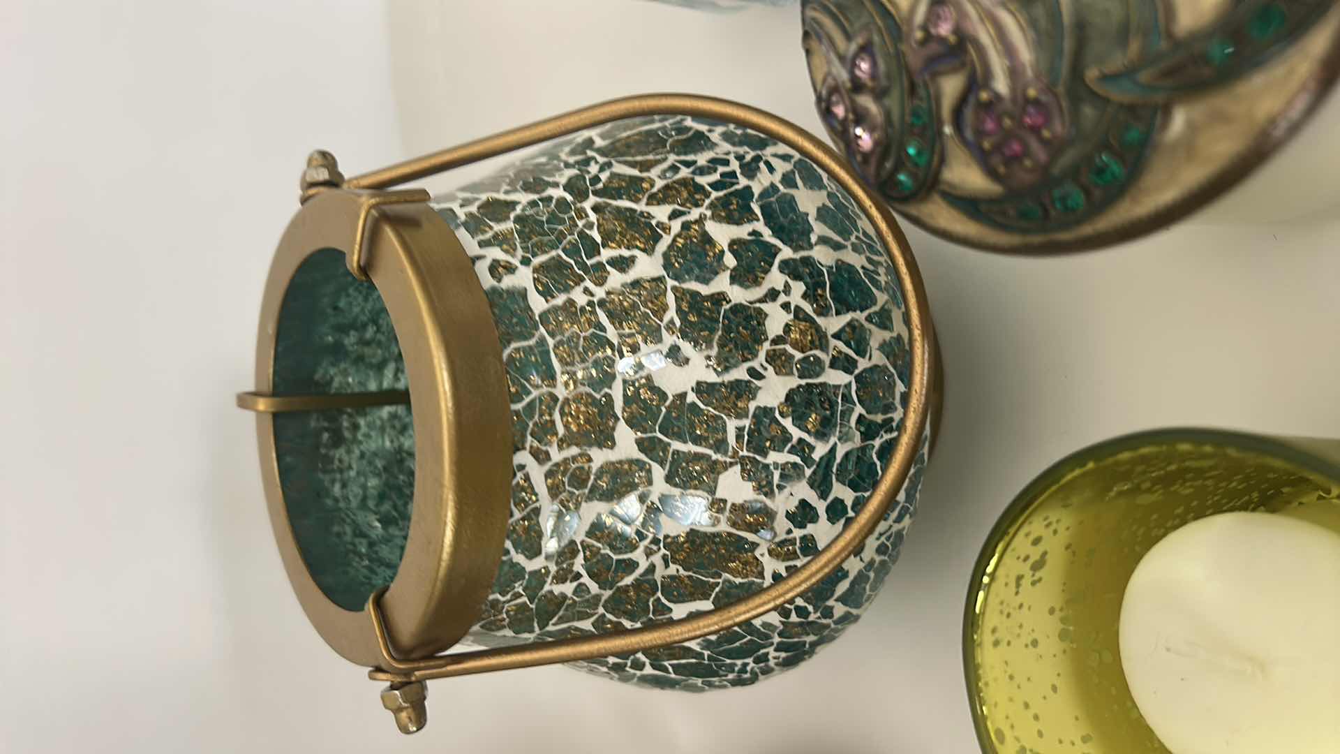 Photo 1 of MOSAIC CANDLE HOLDER LANTERN FEATURES A UNIQUE MIRROR GLASS DESIGN WITH A GOLD HANDLE, DECORATIVE CANDLES AND CANDLE HOLDER WITH  FLOWERS