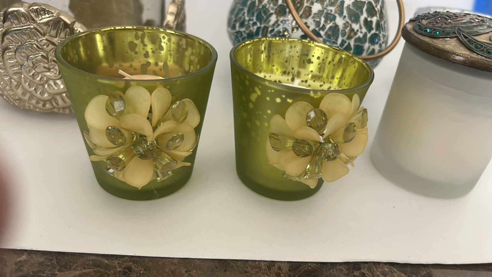 Photo 1 of MOSAIC CANDLE HOLDER LANTERN FEATURES A UNIQUE MIRROR GLASS DESIGN WITH A GOLD HANDLE, DECORATIVE CANDLES AND CANDLE HOLDER WITH  FLOWERS