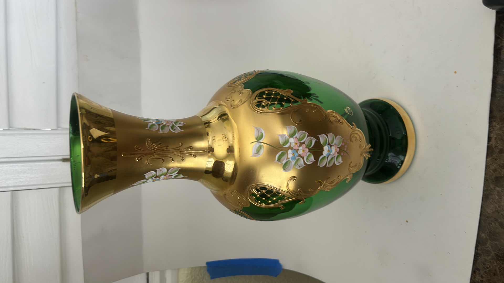 Photo 1 of BOHEMIAN ART GLASS VASE FEATURES A VIBRANT GREEN BODY ADORNED WITH INTRICATE GOLD GILDING & HAND-PAINTED FLORAL ENAMEL DETAILS H16.5”
