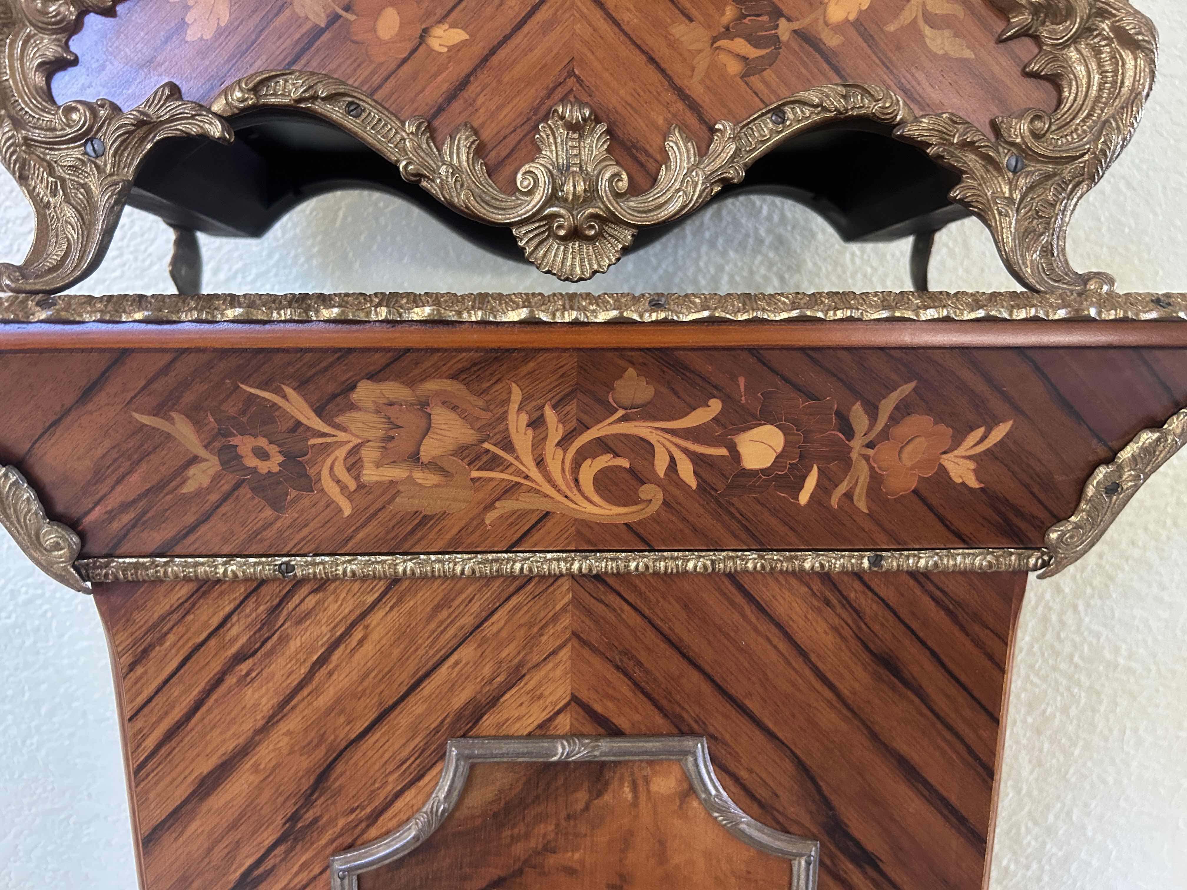 Photo 1 of TIFFANY MADE IN ITALY - FRENCH STYLE VERSAILLES CLOCK FEATURES AN ORNATE GILDED METAL CASE WITH ELABORATE SCROLLWORK, FLORAL MOTIFS, AND A DECORATIVE FINIAL. MATCHING PEDESTAL 14 1/2“ x 6 1/4“ x H31“ PEDESTAL16 1/2” x 9 1/2” x H 44 1/2” TOTAL HEIGHT, INCL