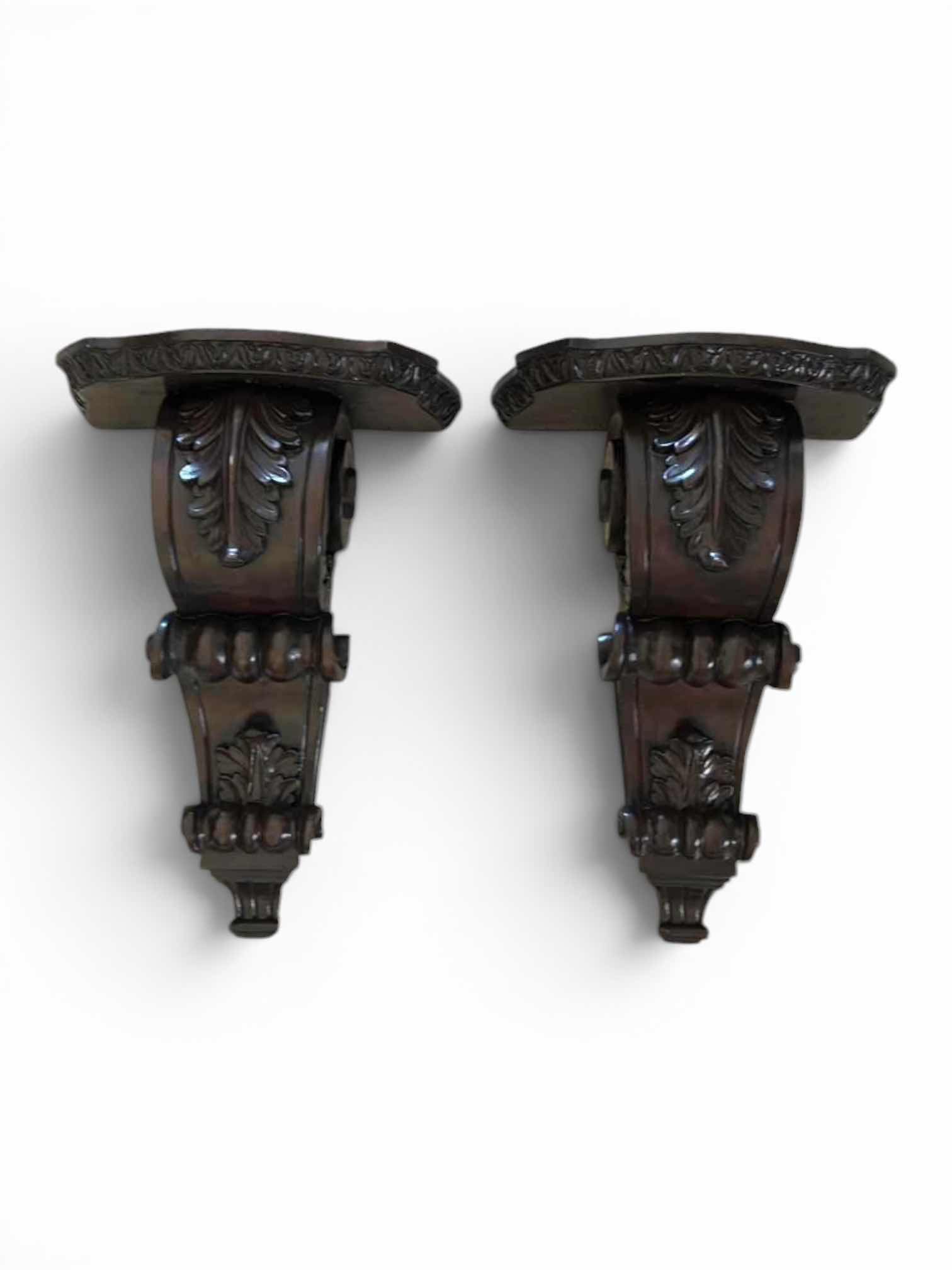 Photo 1 of 2 -MAHOGANY SCONCE CORBELS FEATURE INTRICATE ACANTHUS LEAF CARVINGS AND A RICH, DARK WOOD FINISH. H16” $100