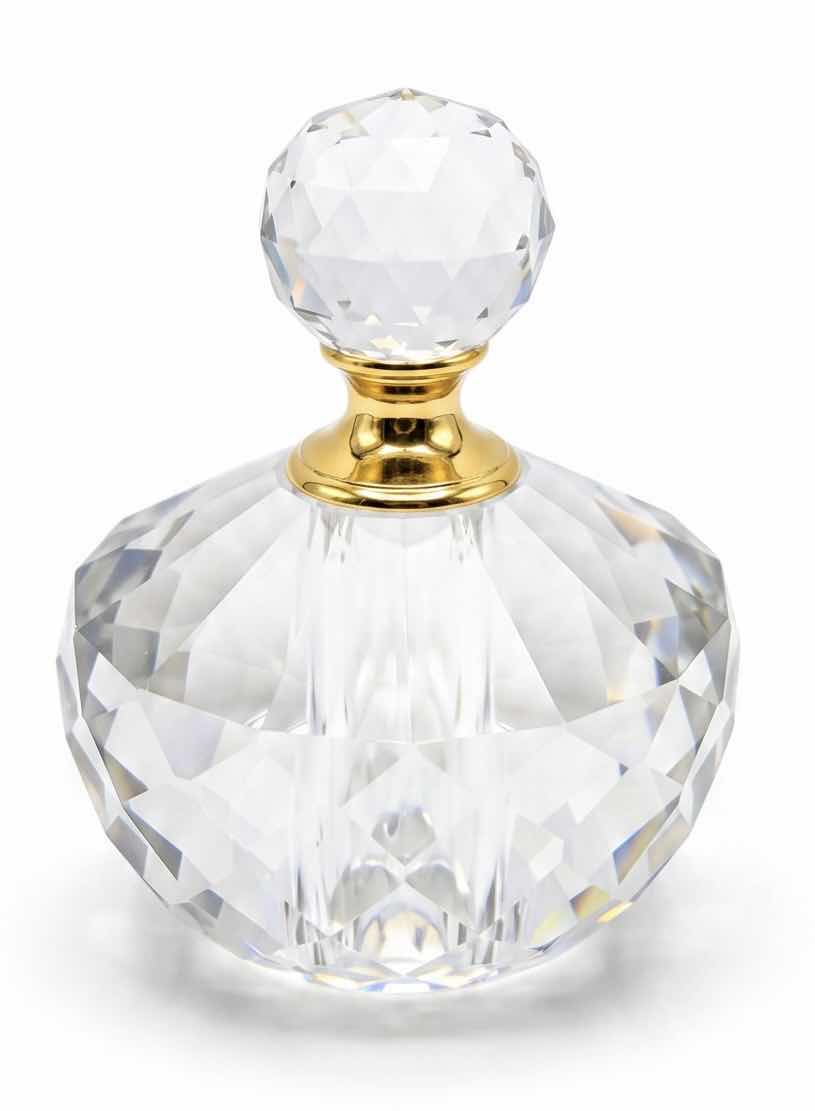 Photo 1 of FACETED CRYSTAL PERFUME BOTTLE FEATURES A DECORATIVE GOLD CAP AND A DISTINCT DIAMOND-SHAPED STOPPER.