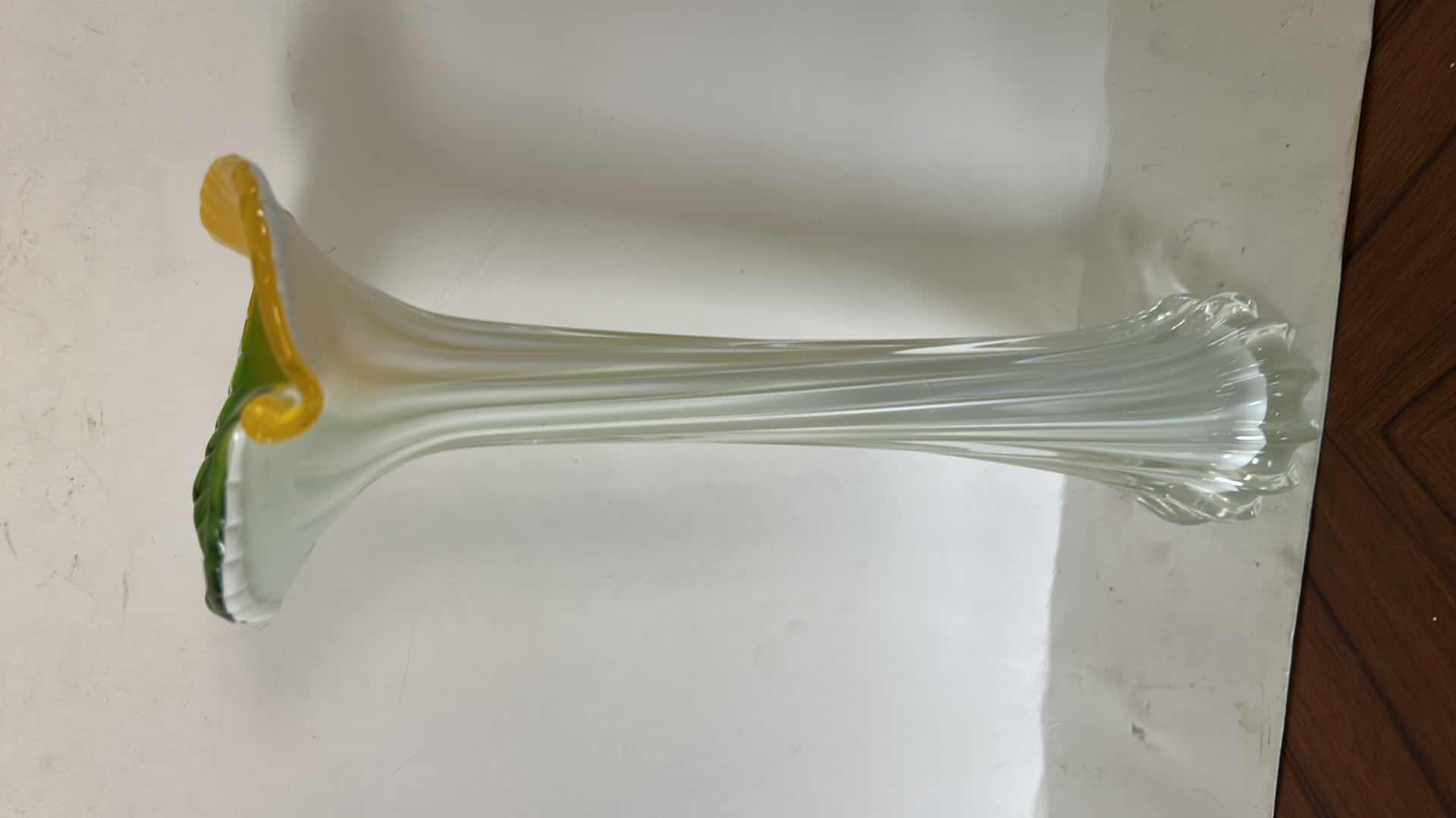 Photo 1 of ART GLASS VASE FEATURES A FLOWER-SHAPED TOP W/VIBRANT GREEN & YELLOW PETALS ATOP A RIBBED WHITE & CLEAR STEM.H12.5”