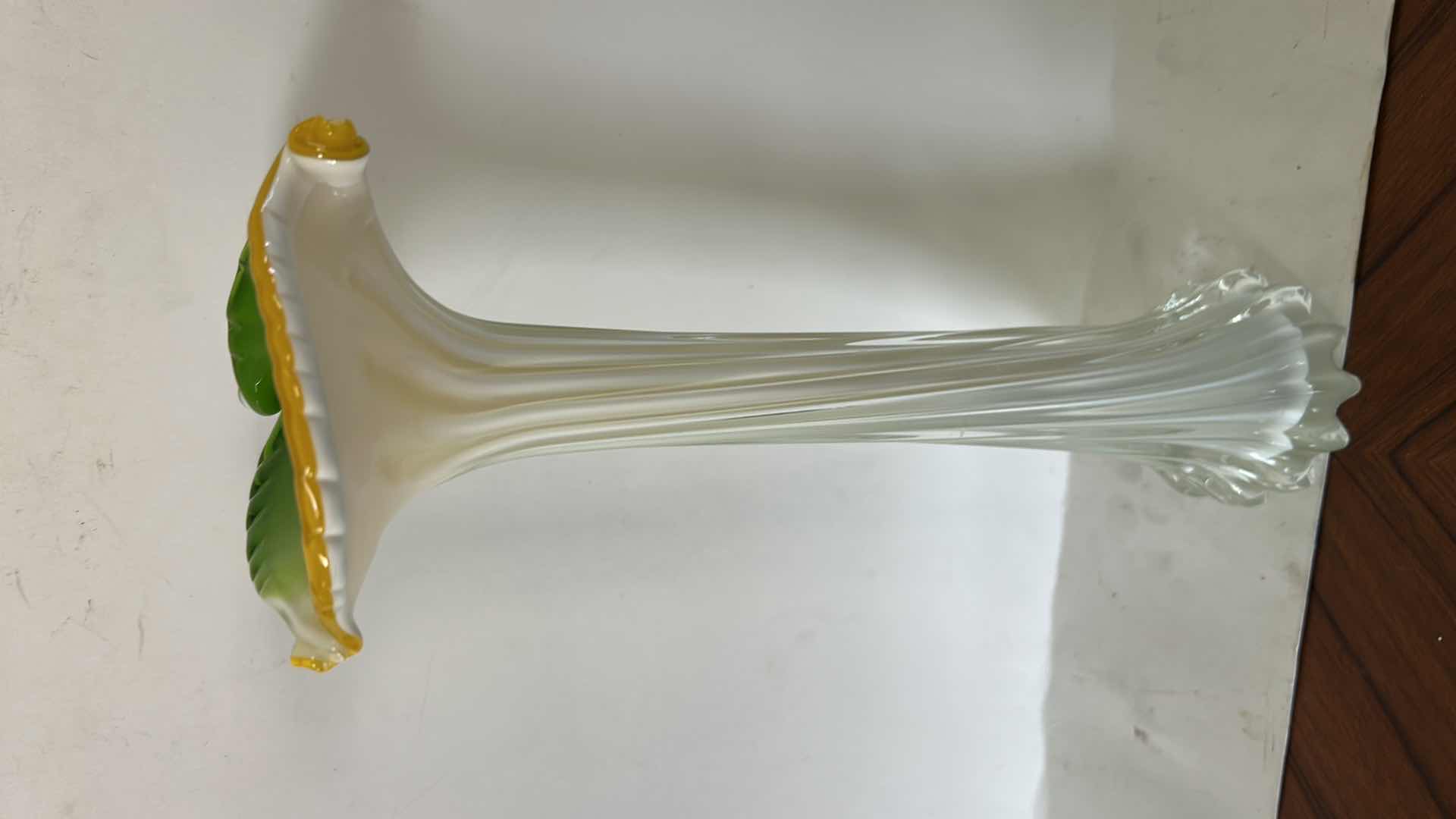 Photo 1 of ART GLASS VASE FEATURES A FLOWER-SHAPED TOP W/VIBRANT GREEN & YELLOW PETALS ATOP A RIBBED WHITE & CLEAR STEM.H12.5”