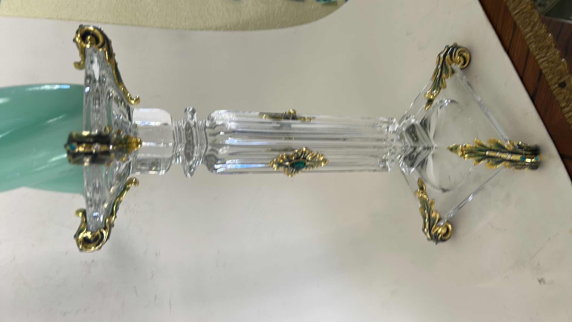 Photo 1 of ORNATE BAROQUE-STYLE CRYSTAL CANDLESTICK FEATURES DISTINCTIVE GOLD-LEAF EMBELLISHMENTS AND EMERALD-COLORED JEWEL ACCENTS. H13” & BATTERY OPERATED CANDLE.
