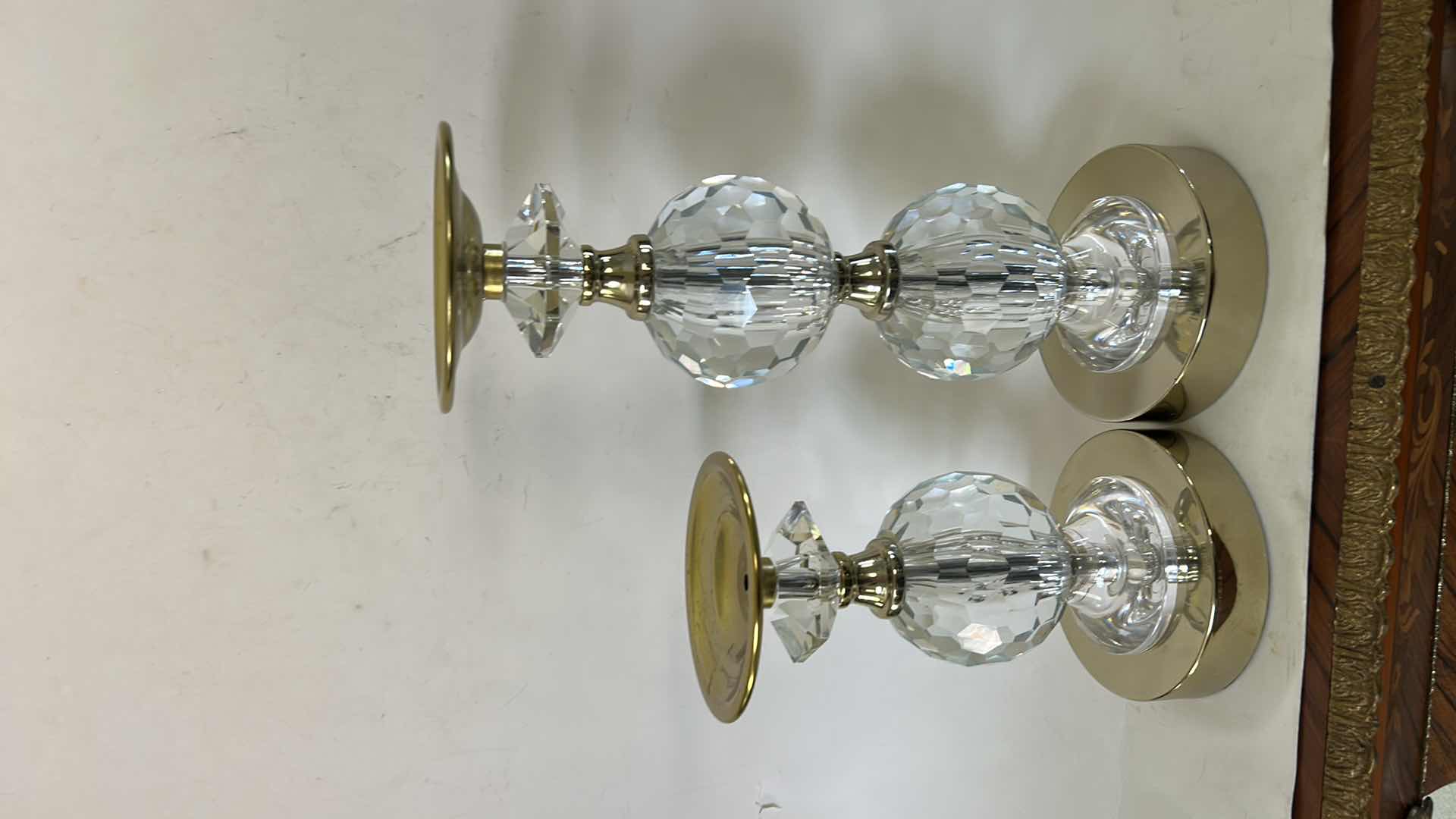 Photo 1 of 2- LOLA GOLD PILLAR CANDLEHOLDERS FROM TOUCH OF CLASS FEATURE FACETED CRYSTAL ACCENTS AND A POLISHED GOLD-FINISHED METAL BASE. (TALLEST H12”) $150