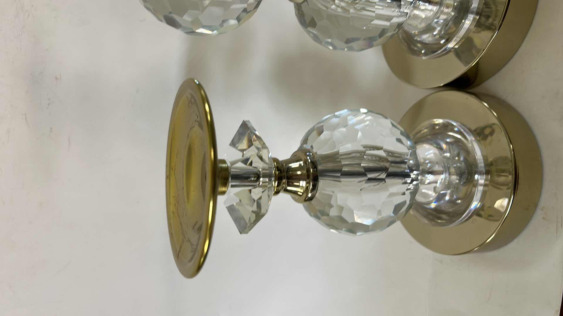 Photo 1 of 2- LOLA GOLD PILLAR CANDLEHOLDERS FROM TOUCH OF CLASS FEATURE FACETED CRYSTAL ACCENTS AND A POLISHED GOLD-FINISHED METAL BASE. (TALLEST H12”) $150