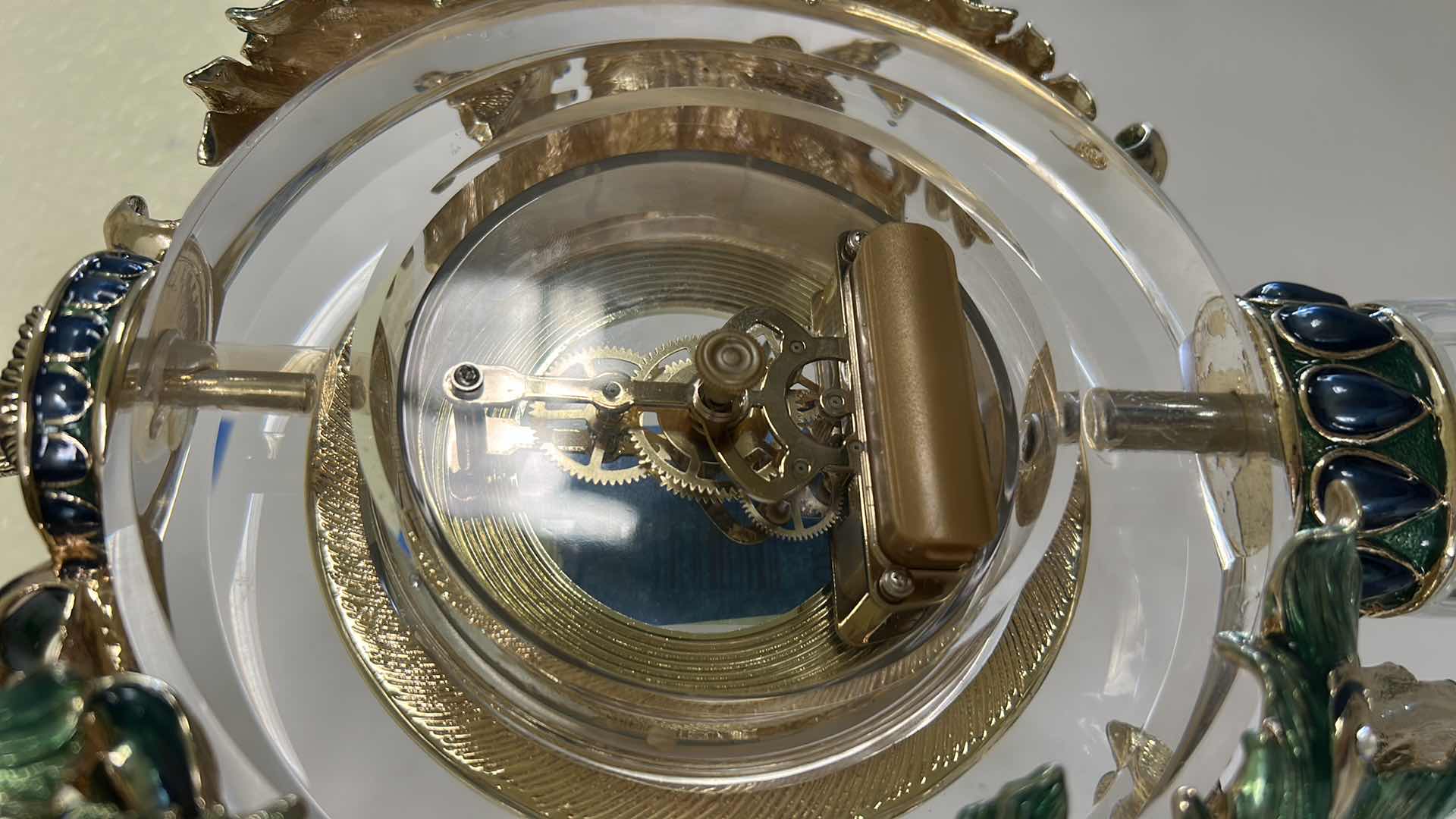 Photo 1 of REGIS GALERIE PEACOCK CRYSTAL CLOCK FEATURES AN ORNATE, ENAMELED PEACOCK FIGURE PERCHED ATOP A CLEAR CRYSTAL STAND H 24”