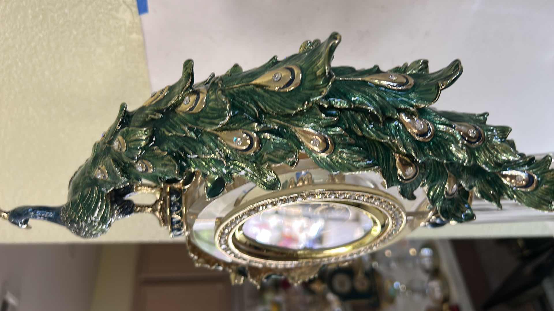Photo 1 of REGIS GALERIE PEACOCK CRYSTAL CLOCK FEATURES AN ORNATE, ENAMELED PEACOCK FIGURE PERCHED ATOP A CLEAR CRYSTAL STAND H 24”