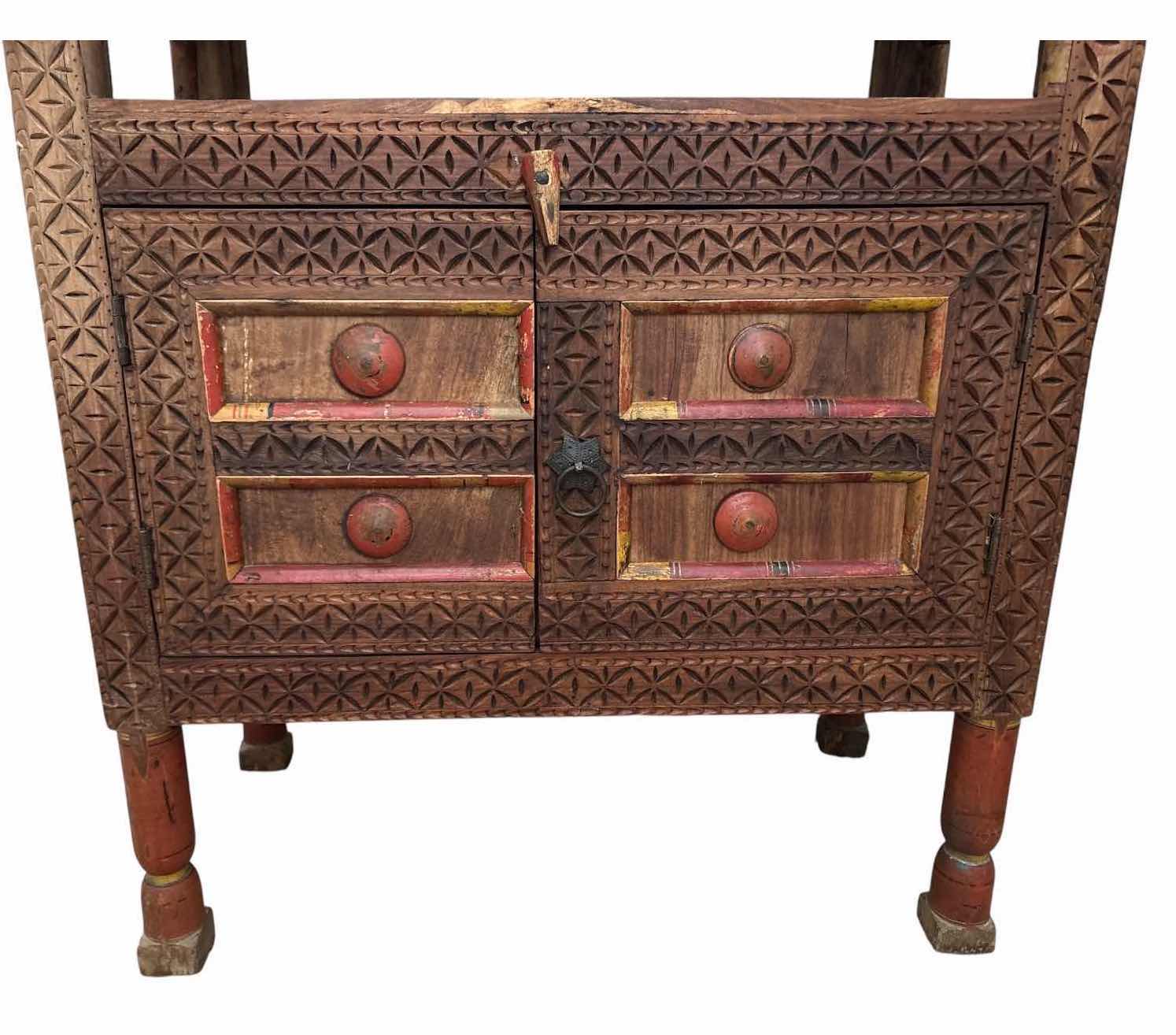 Photo 1 of HAND-CARVED WOOD ACCENT CABINET W/OPEN SHELF, TWO DOORS, INTERIOR STORAGE, AND DISTRESSED PAINTED ACCENTS 32”X16.5”H45”