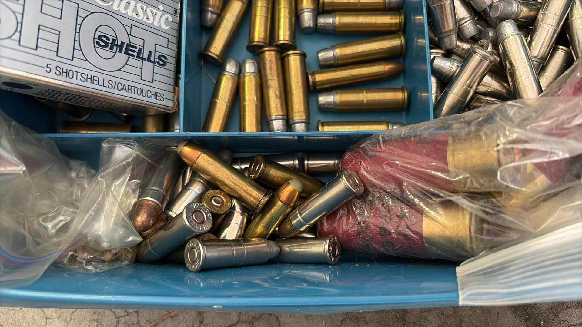 Photo 1 of SMALL PLASTIC CONTAINER FULL OF LOOSE AMMUNITION