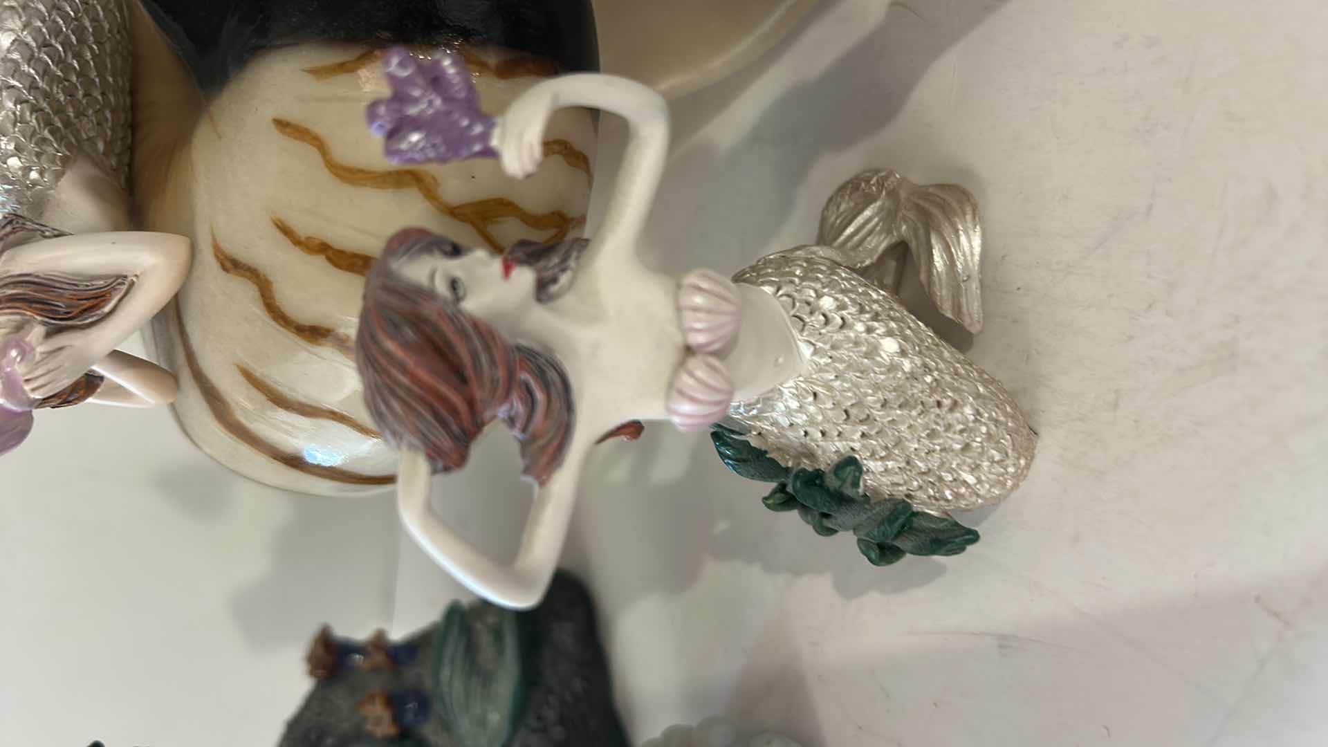 Photo 1 of 10 - SMALL MERMAID FIGURINES AND ONE SHELL.