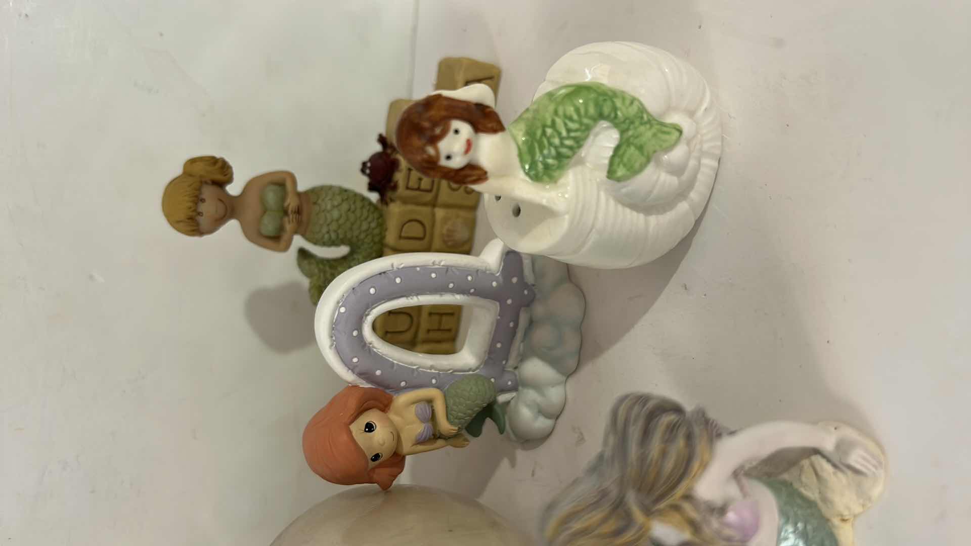 Photo 1 of 10 - SMALL MERMAID FIGURINES AND ONE SHELL.