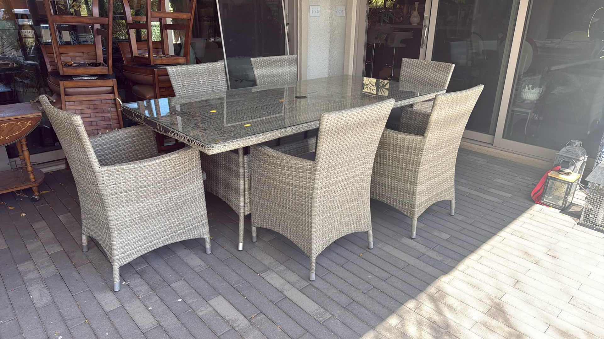 Photo 1 of WICKER PATIO LIGHT GRAY TABLE W GLASS TOP PROTECTOR & 6 ARM CHAIRS 79” x 40” H29” (SEE NOTES)
