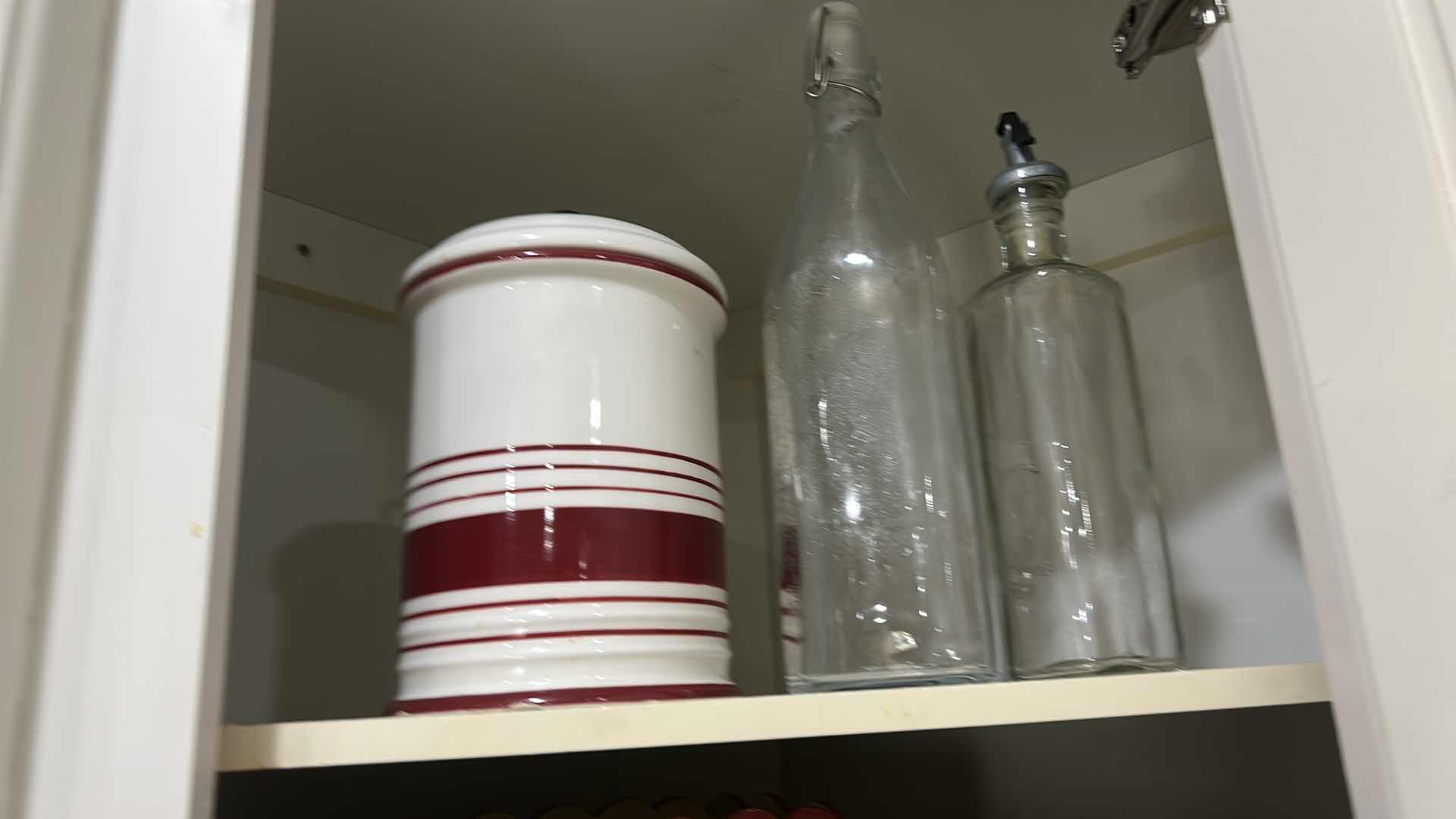 Photo 1 of CONTENTS OF CABINET IN KITCHEN,  CANISTER, TEA, POT, TRIVETS, AND MORE